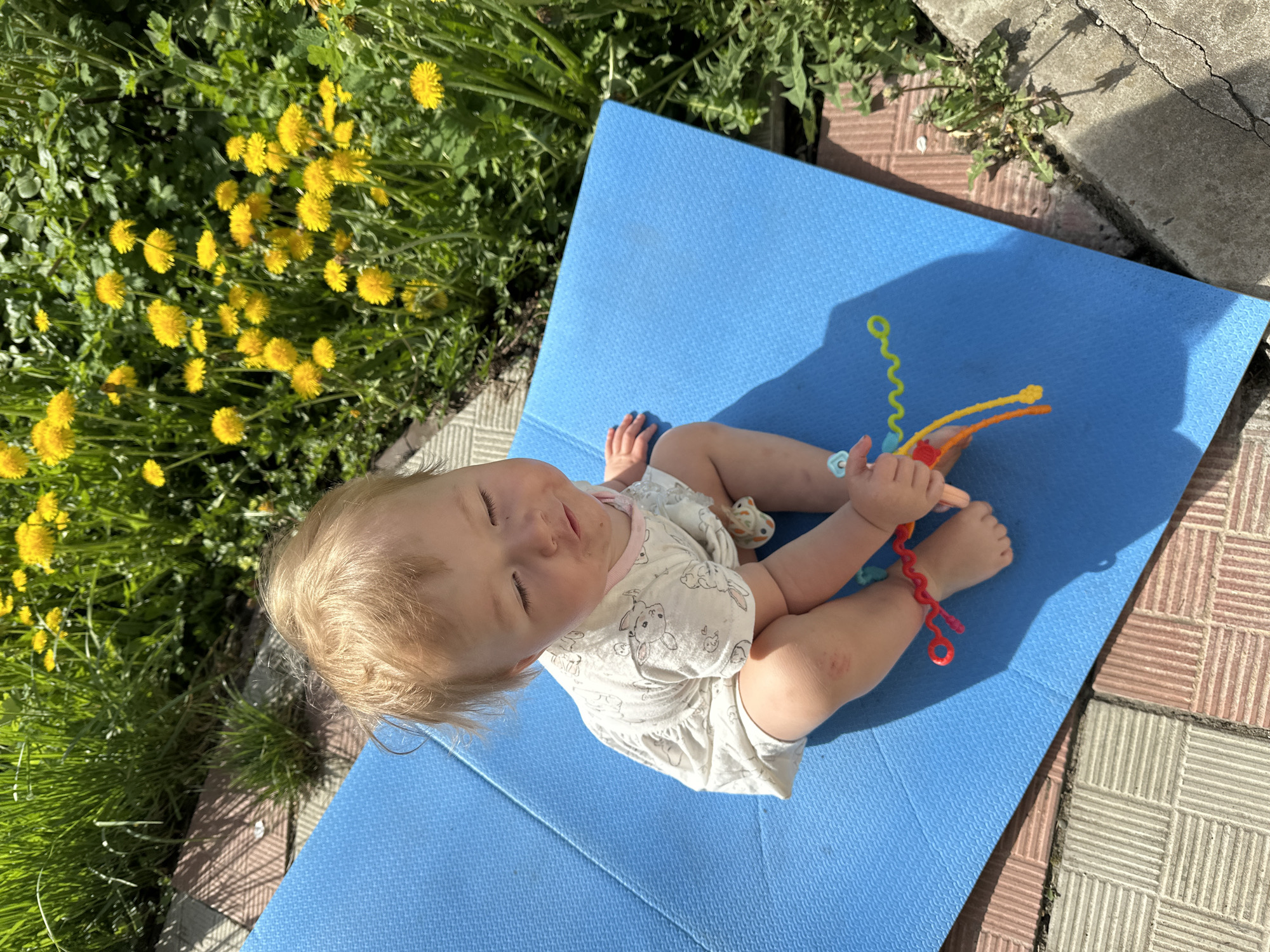 Baby plays outdoors on patio in Nizhny Novgorod, Russia