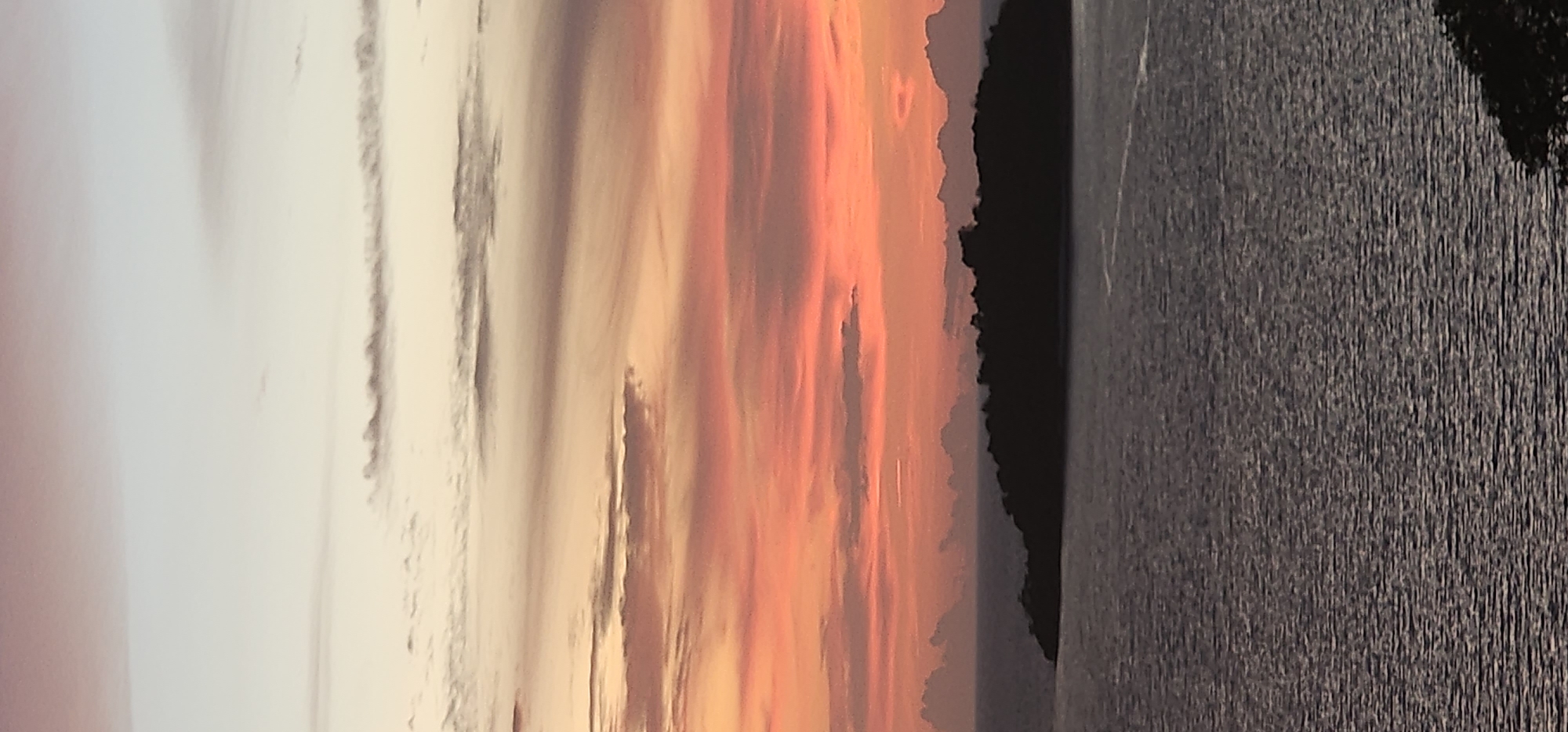 Sunset on the Ko Samui coast, sky ablaze, figure mid-air