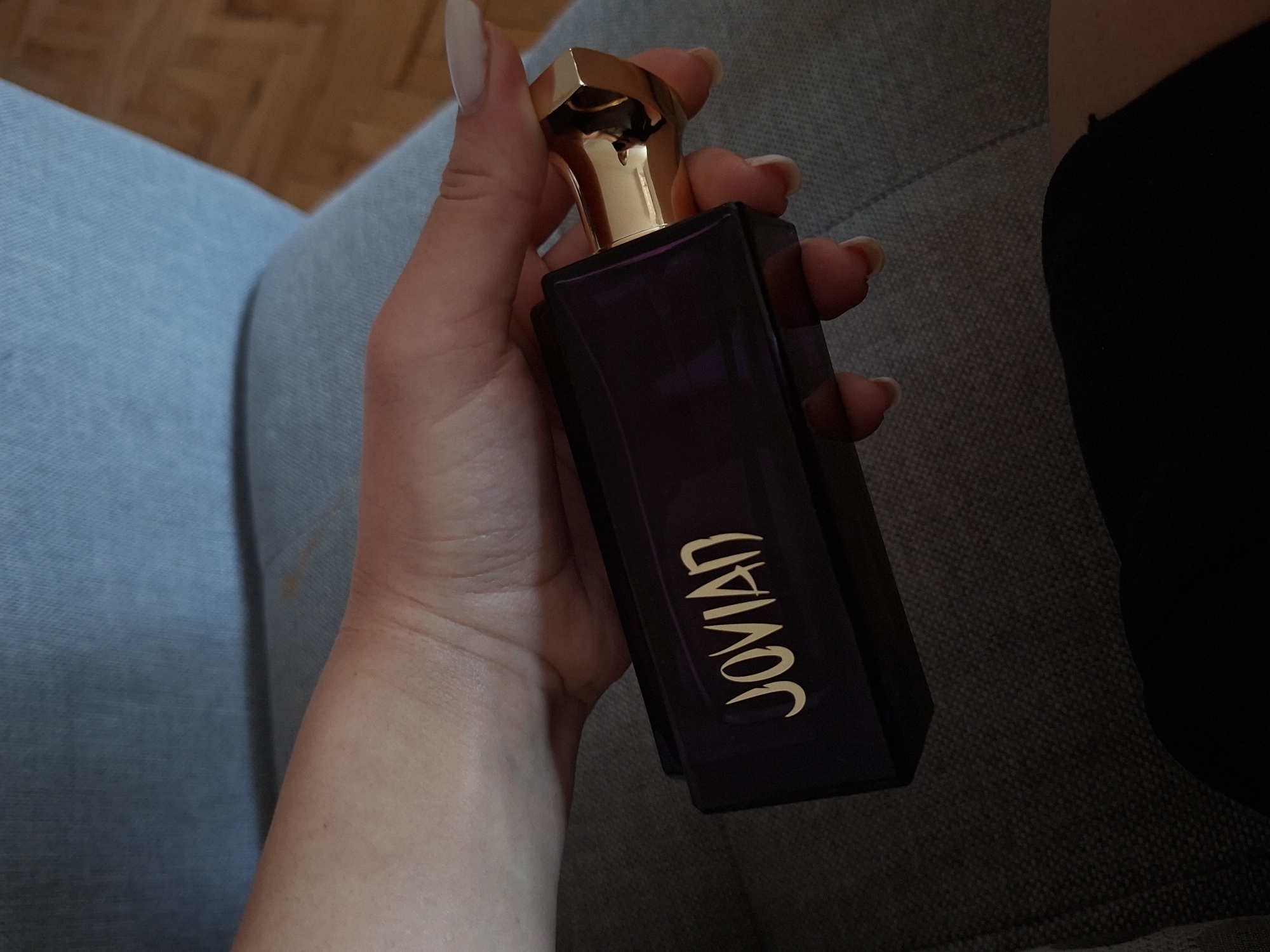 Person holds Jovian perfume bottle in Pleven, Bulgaria