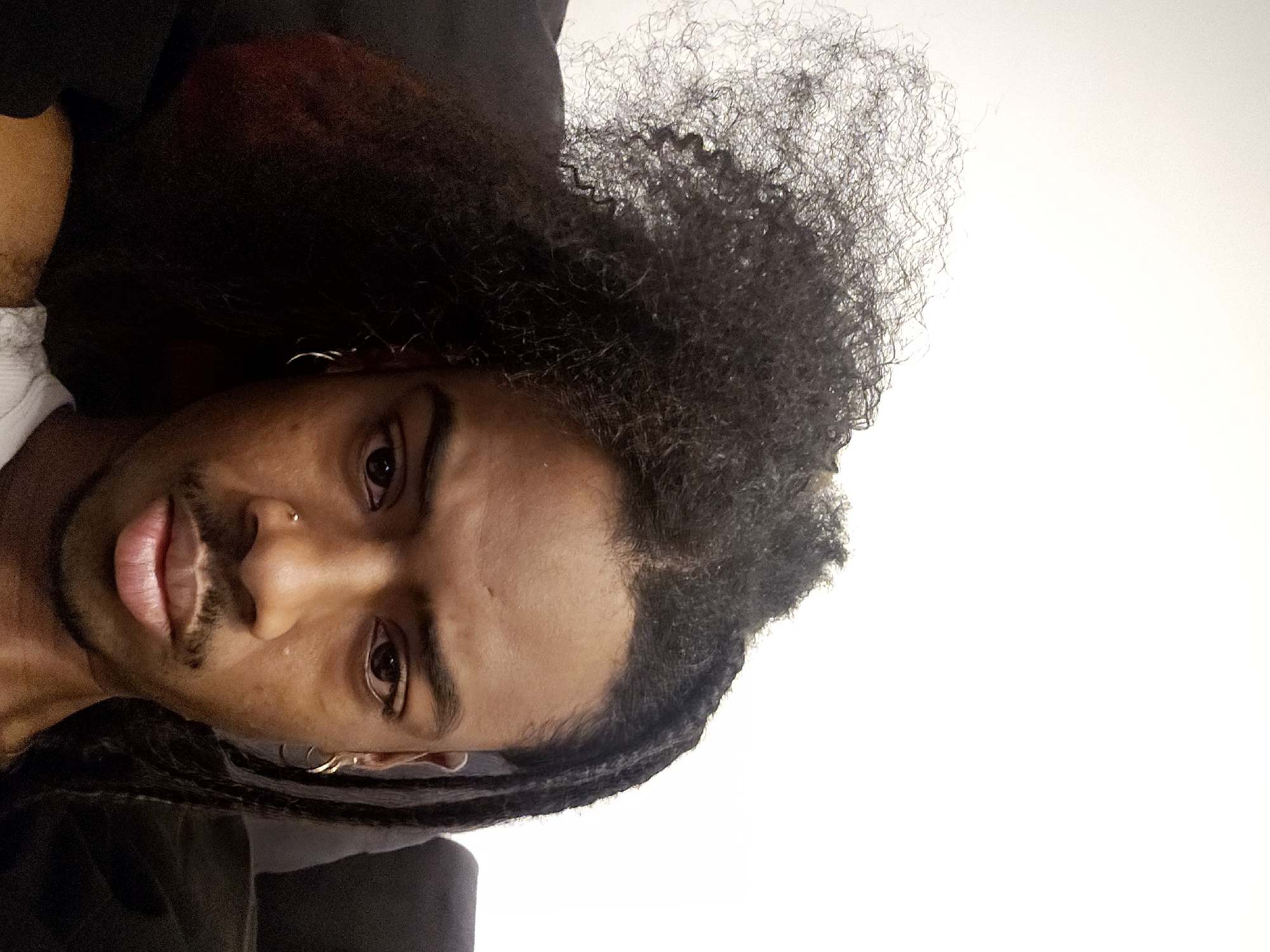 Portrait of man with braided hairstyle captured in Pantin