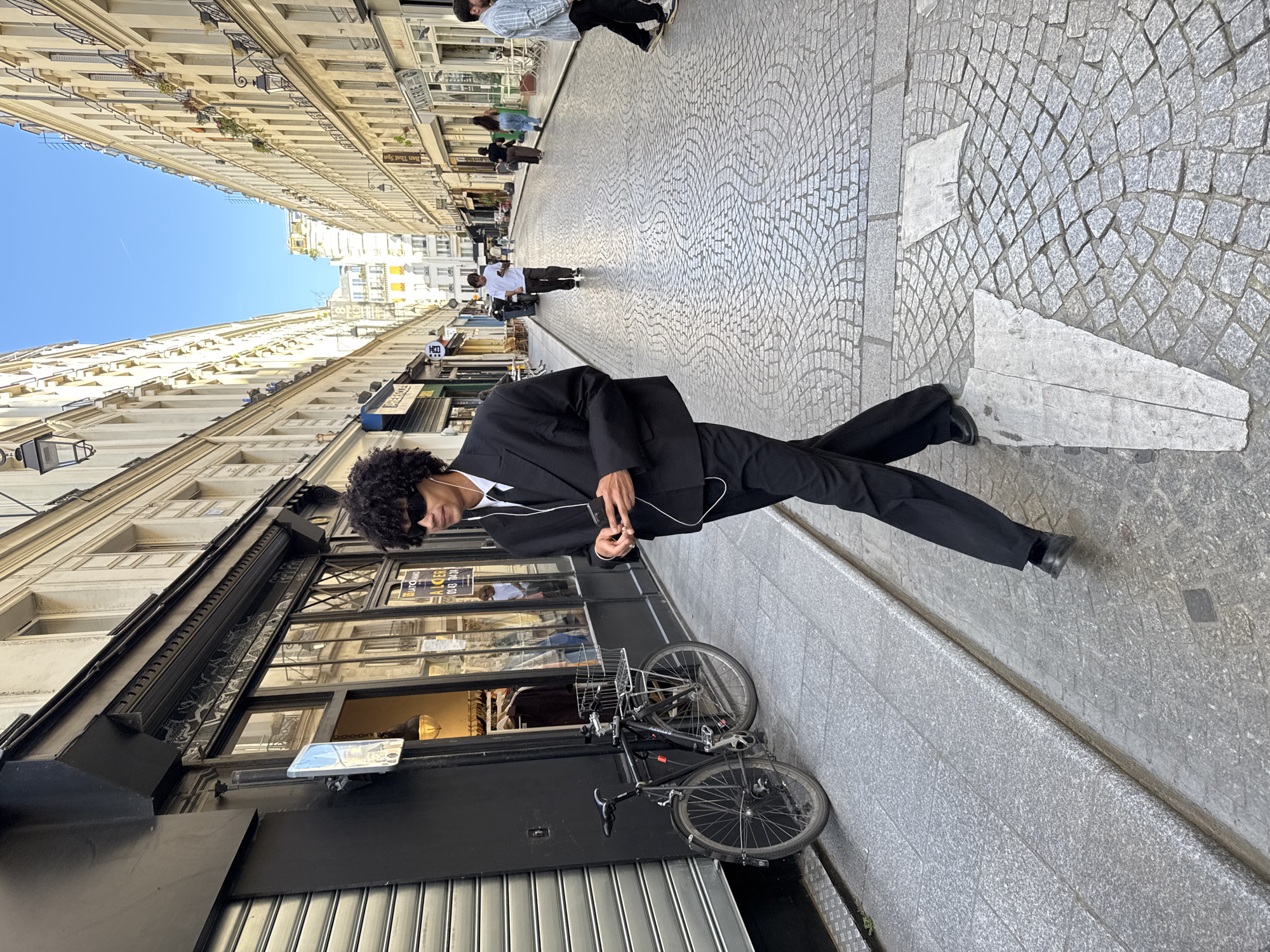 Three young men photographed on Paris cobblestone street