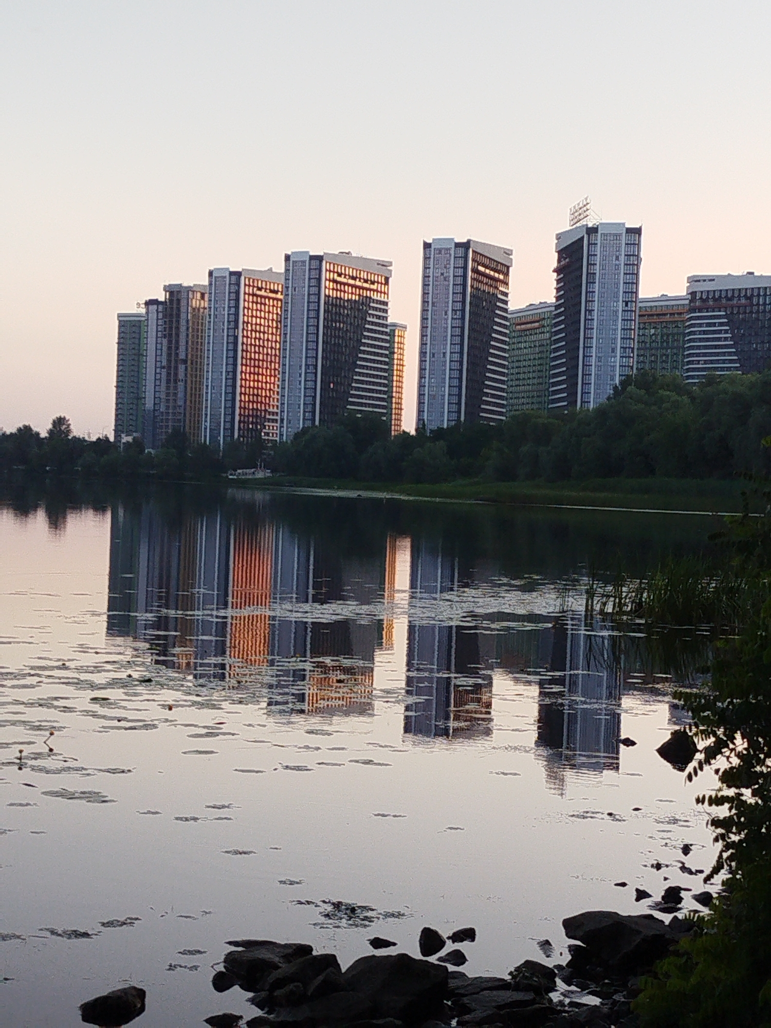 City waterfront at dusk, bridges and ducks and still reflections