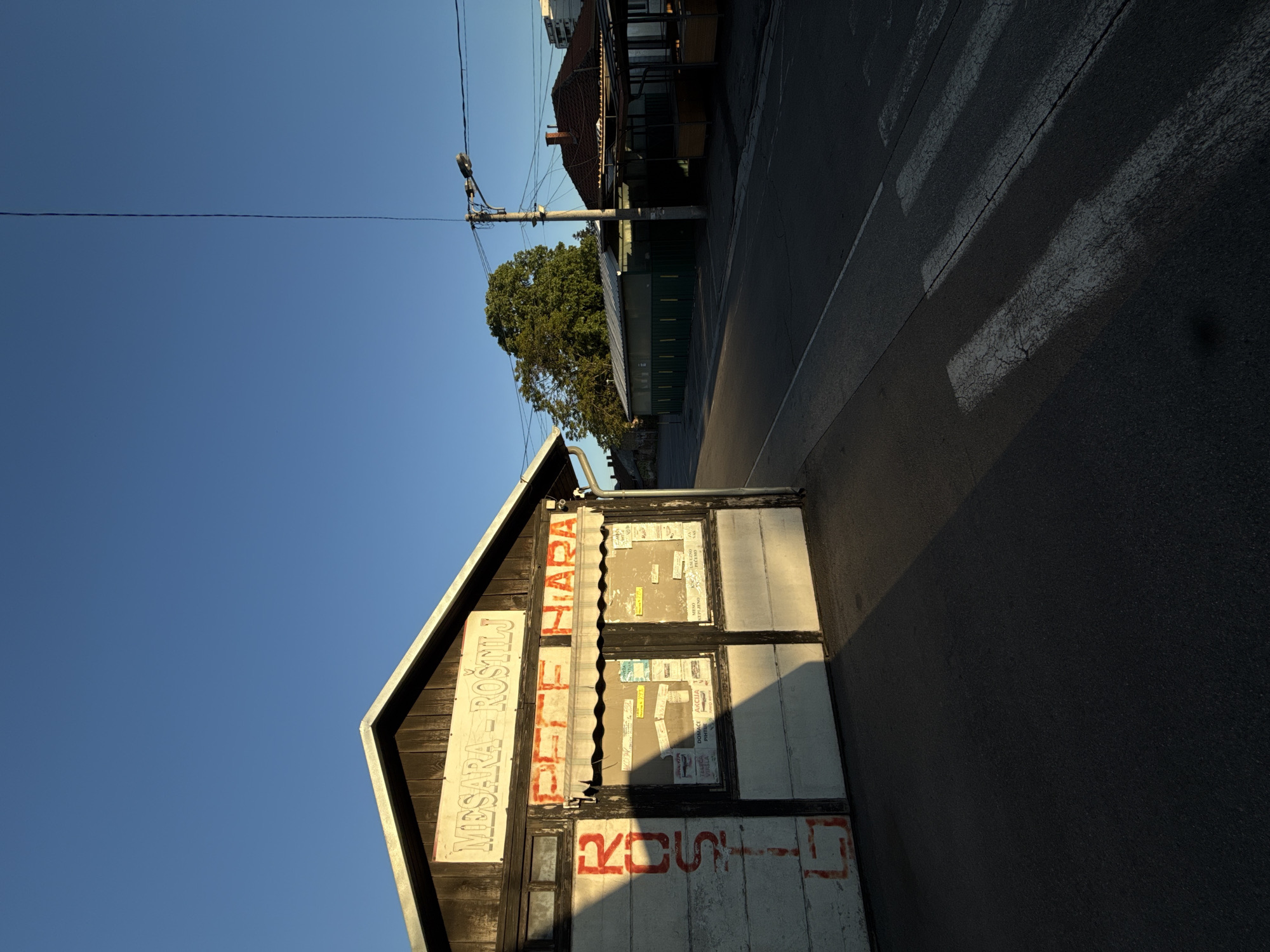 Evening scenes captured in Vozdovac: local shop and highway traffic