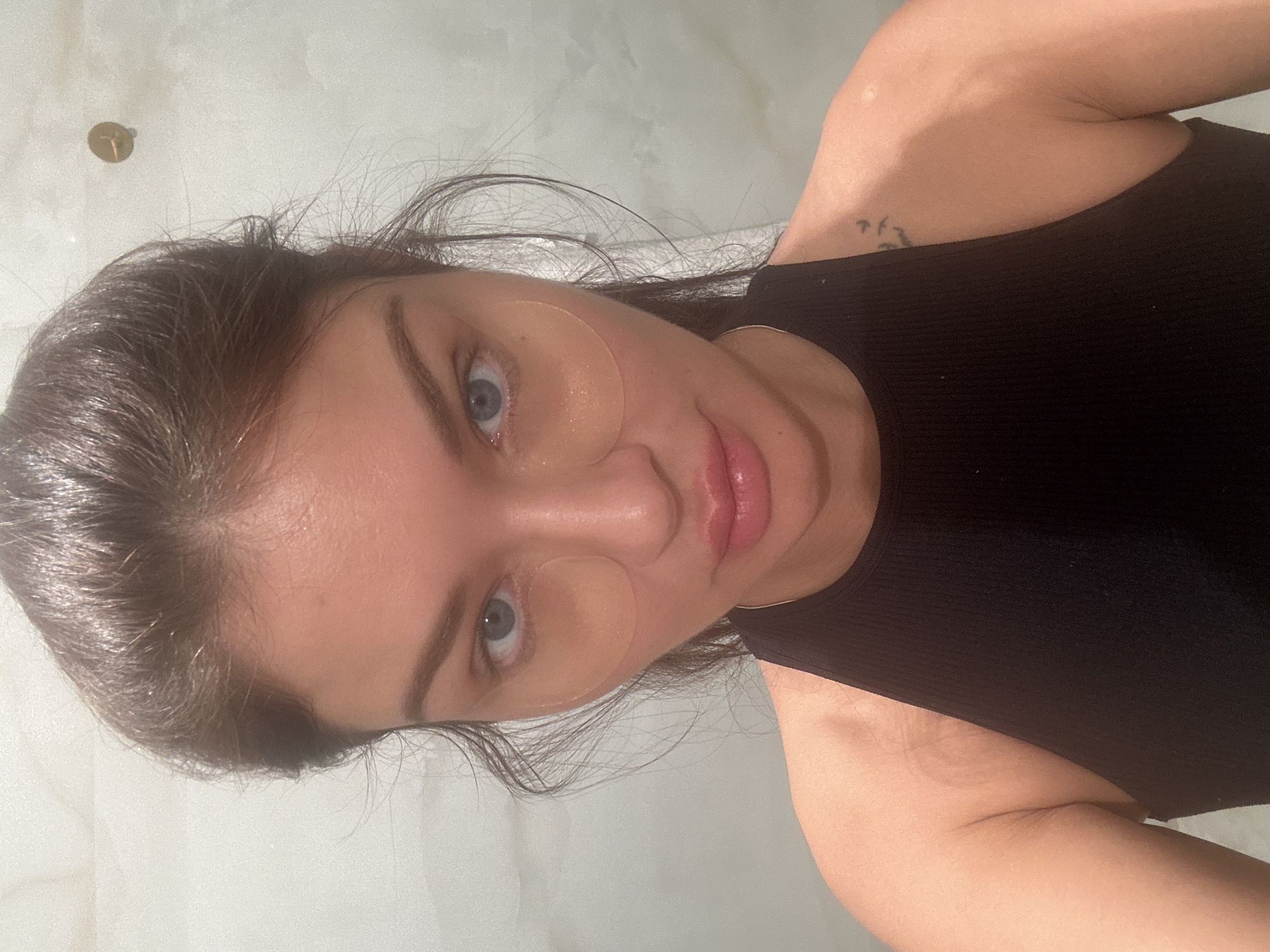 Woman applies skincare patches in Moscow selfie session
