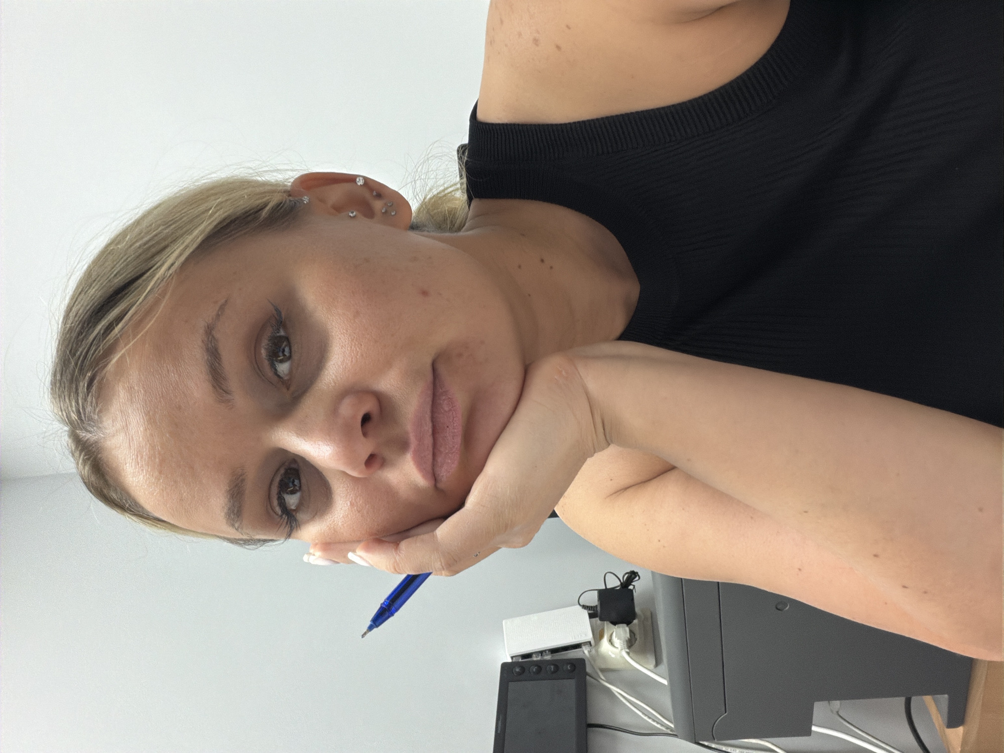 Woman rests with pen in hand in Sarapul