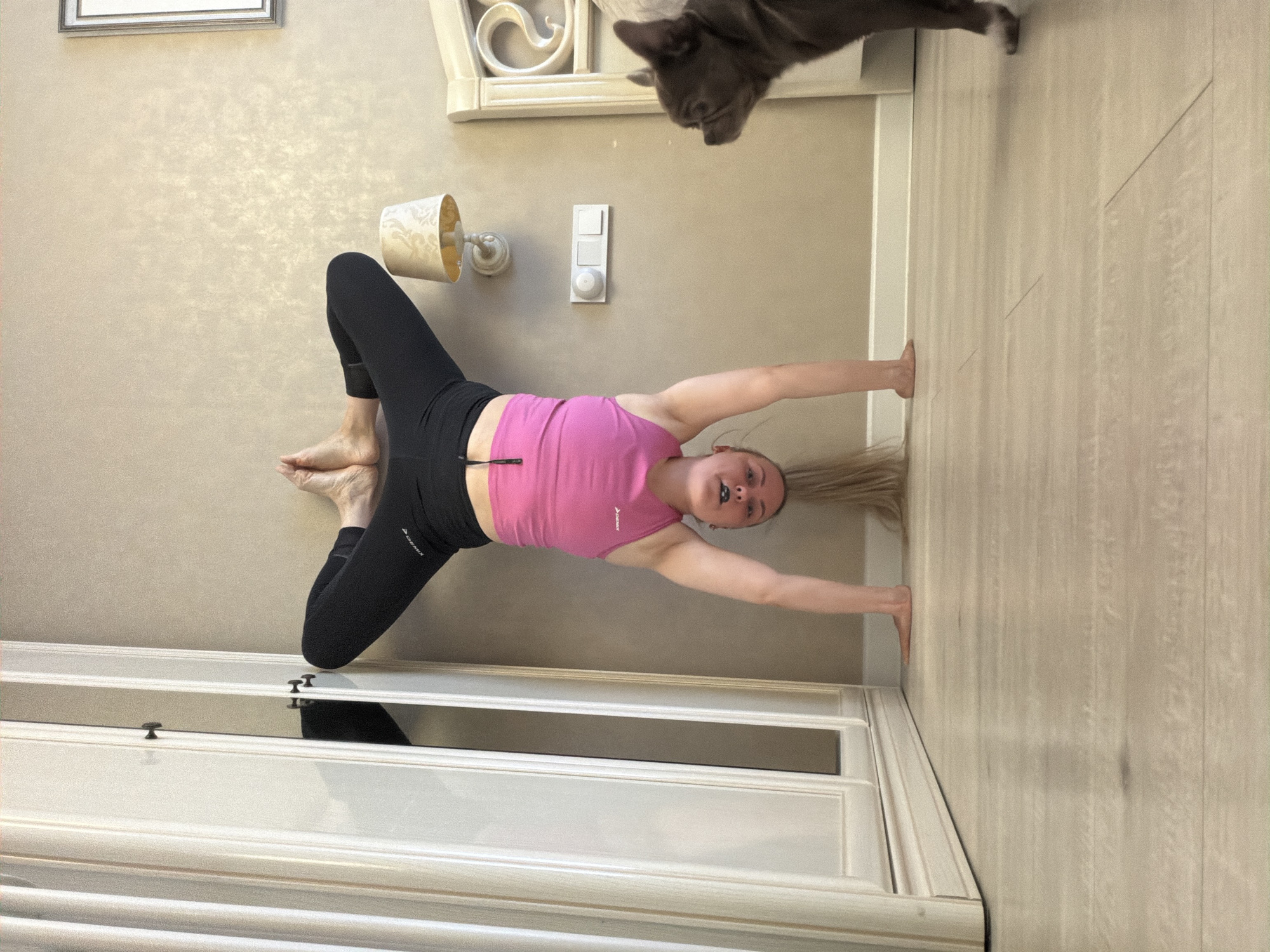 Woman practices yoga with cat in Votkinsk home