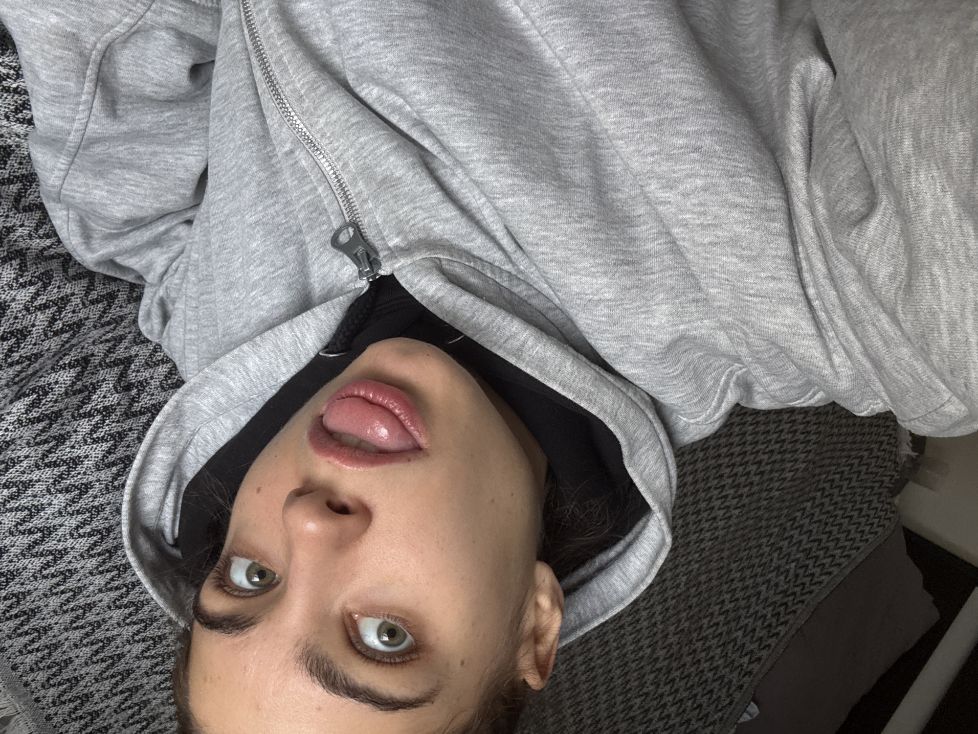 Woman lying down with tongue out observed in Moscow