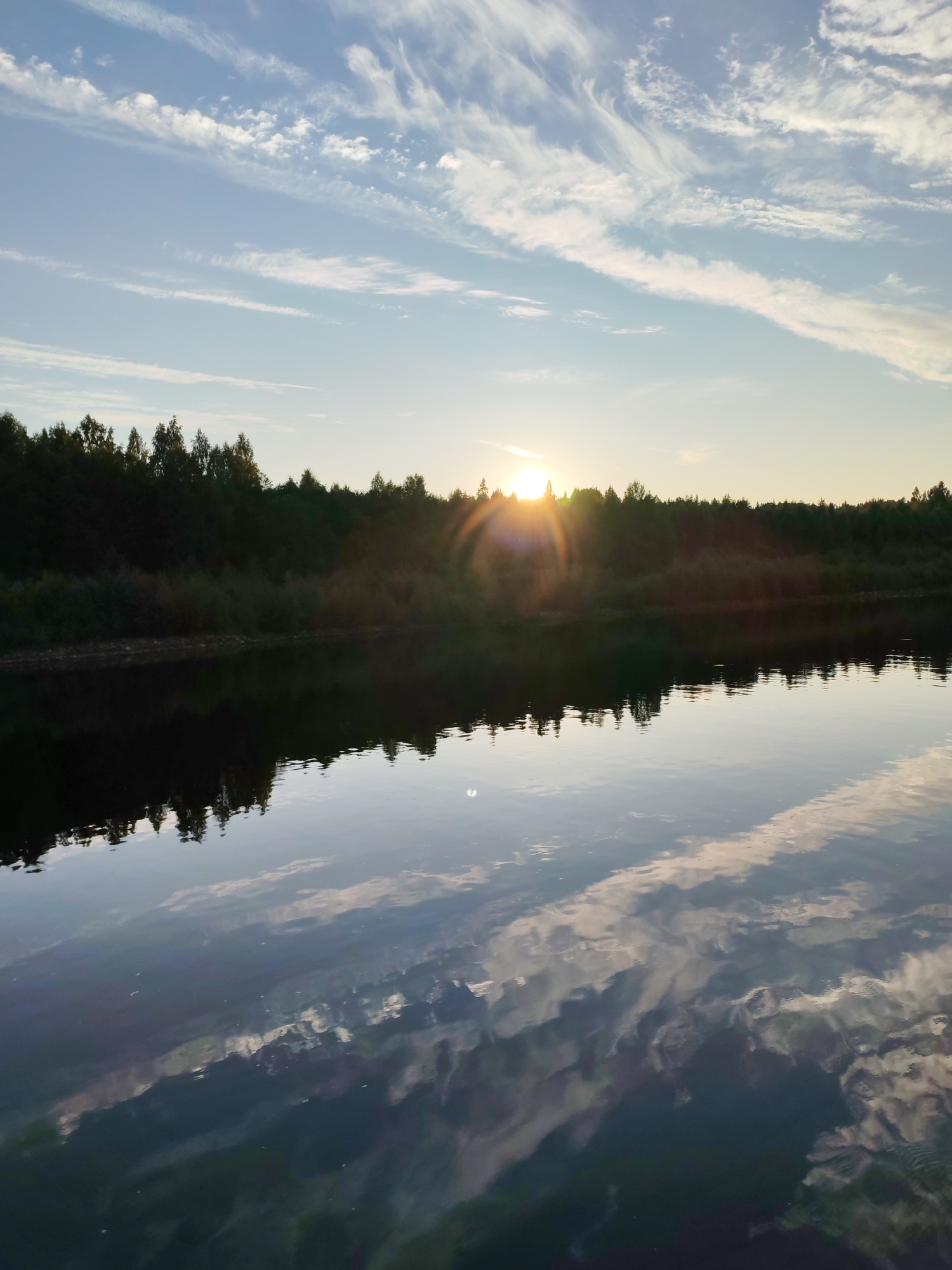 Barge navigating a calm river near Annenskii Most at dusk