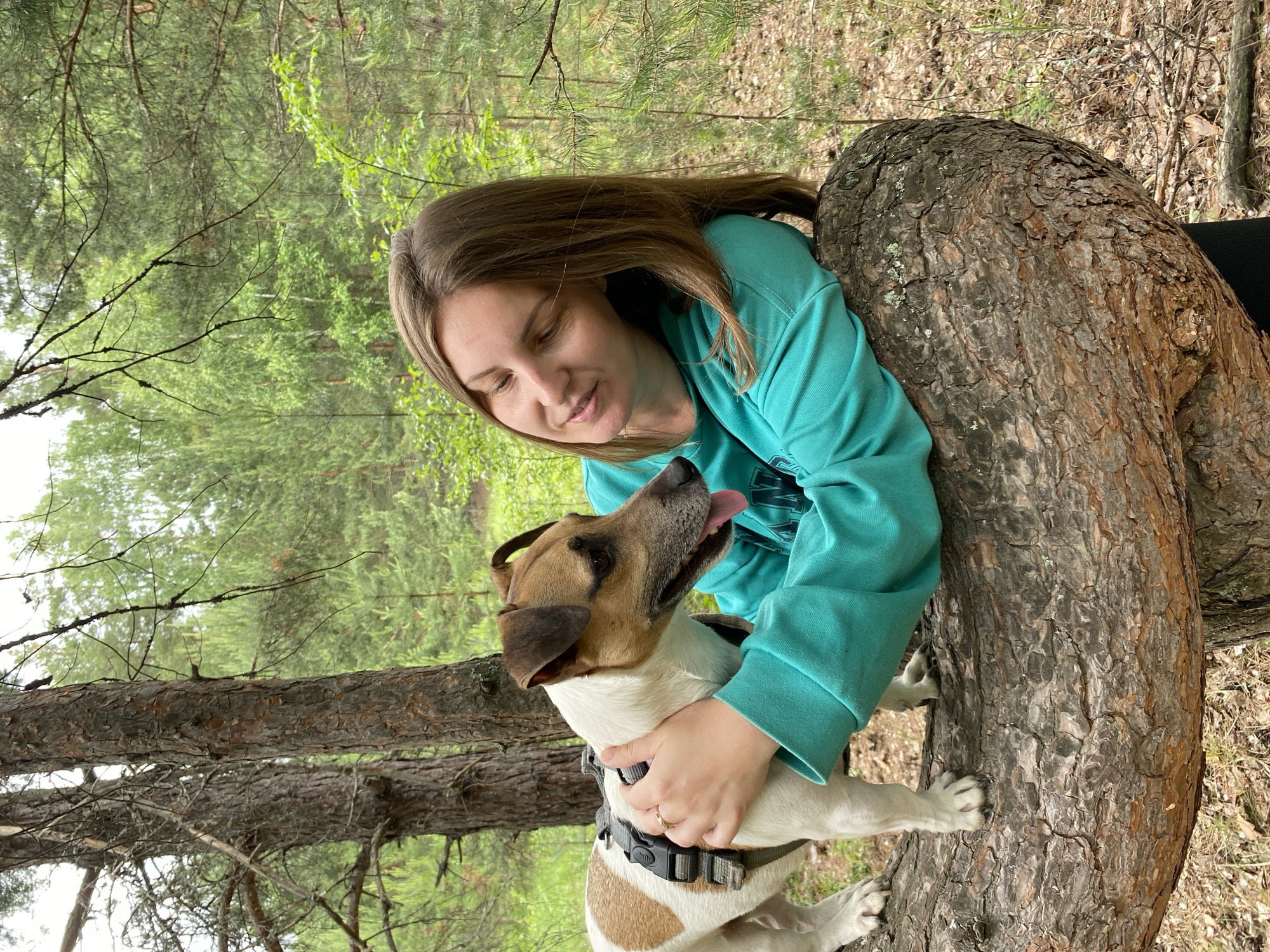 Woman and dog enjoy forest outing in Noviy, Russia