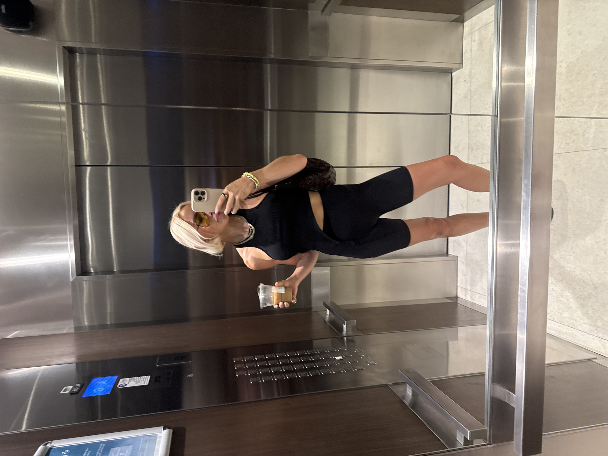 Woman takes elevator selfie in Dubai wearing black outfit