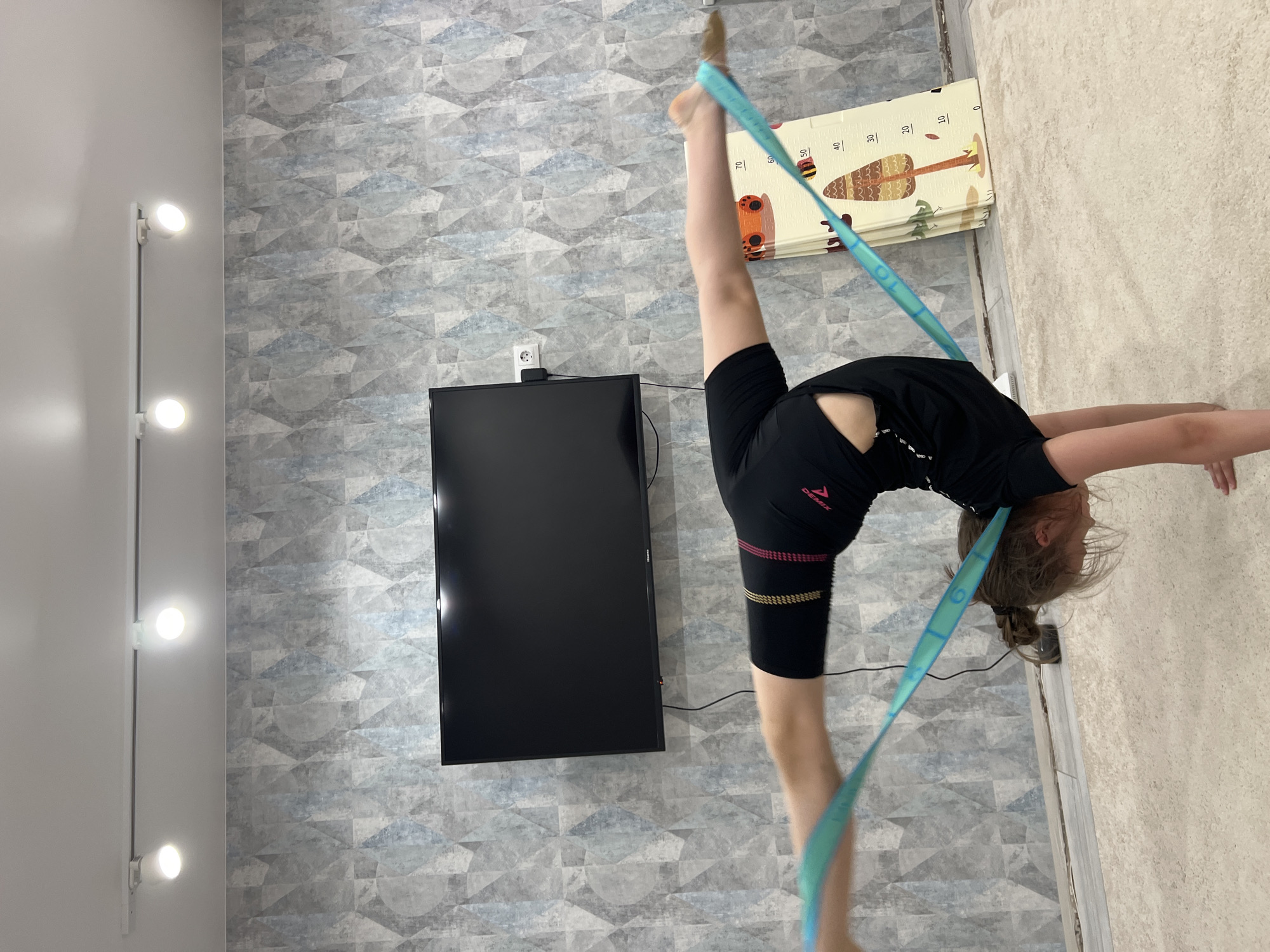 Gymnast trains indoors while spring scenes unfold in Chaikovsky