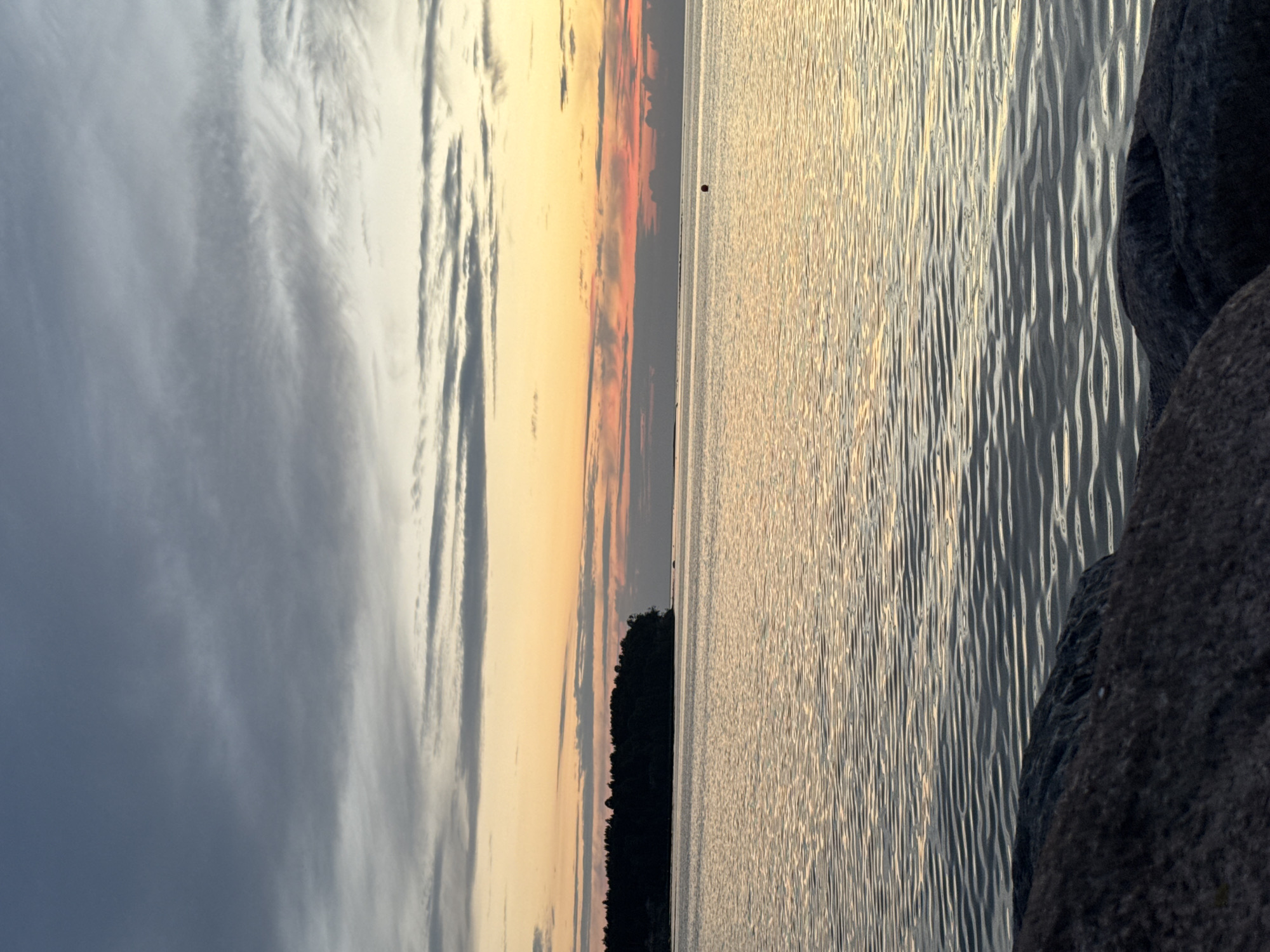 Sunset over rocky Baltic shoreline near Tallinn