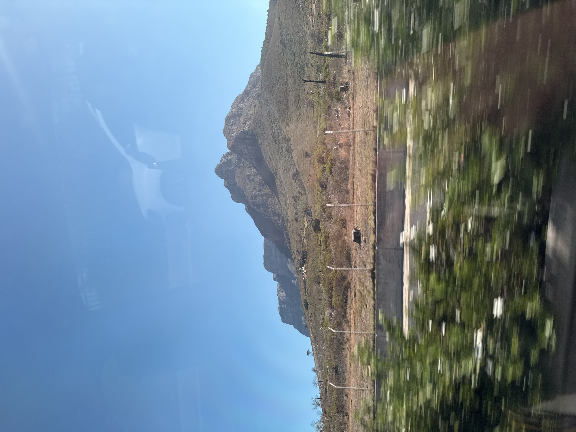 Mountain landscape photographed from moving vehicle in Cape Town
