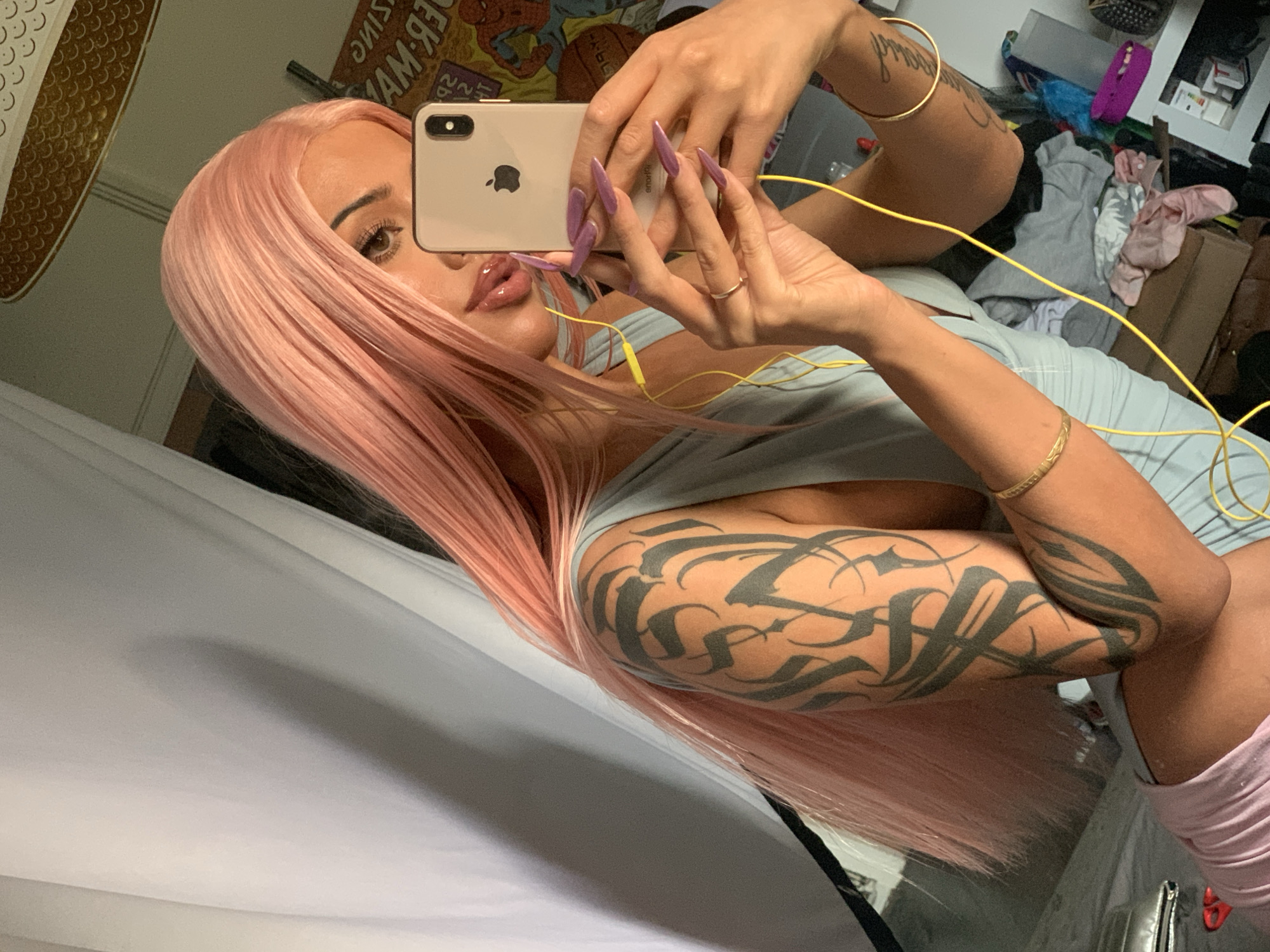 Woman in pink wig takes selfie in London