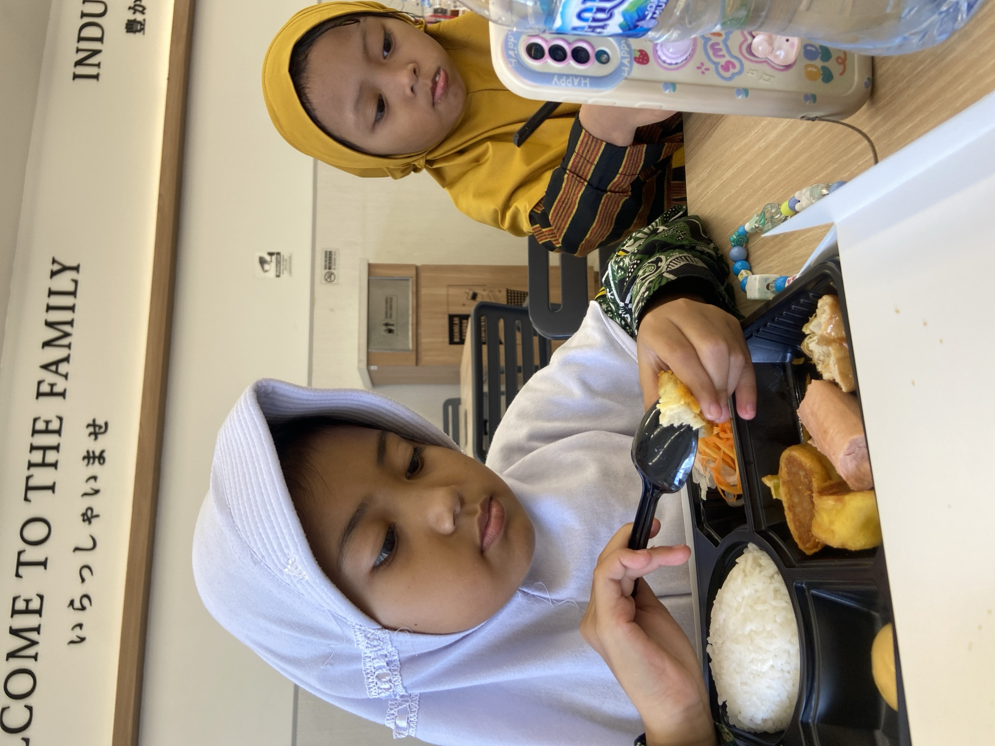 Children share meal at Sidoarjo restaurant early morning