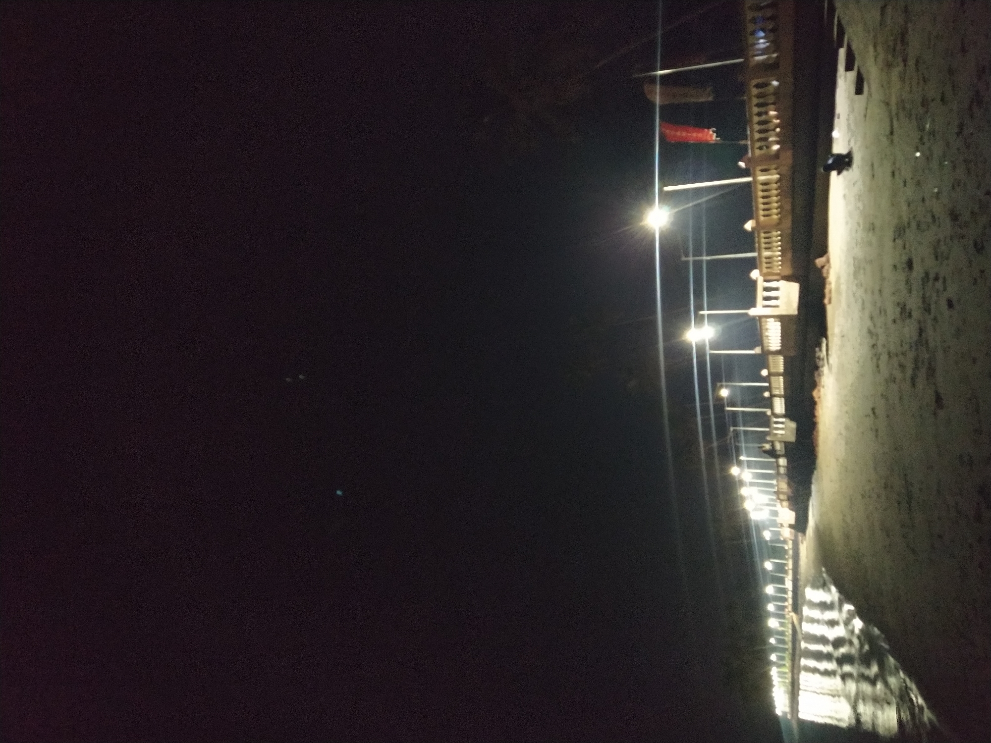 Nighttime waterfront promenade documented in Badem, India