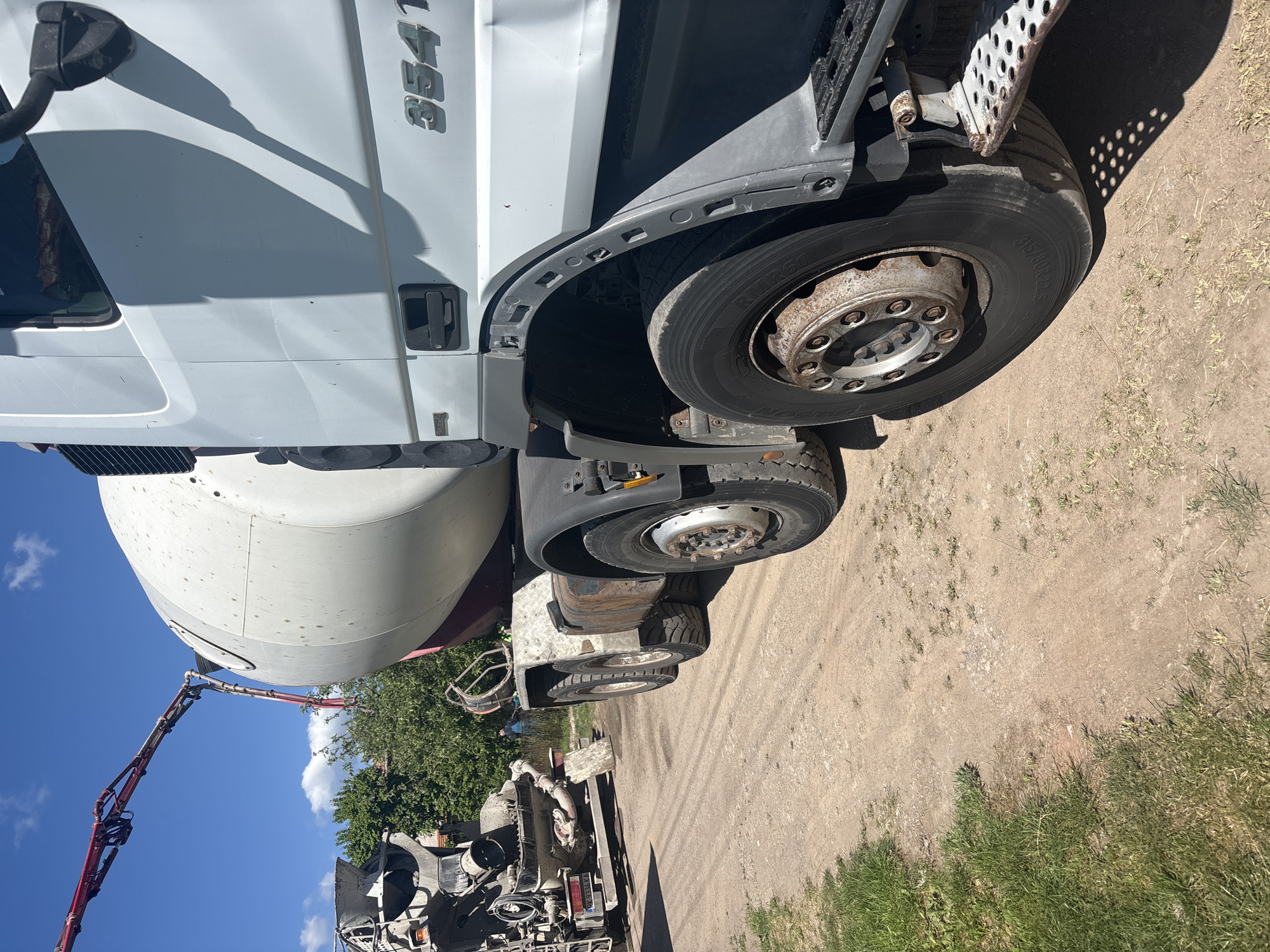 Concrete mixer truck parked on dirt road in Bulgarian village