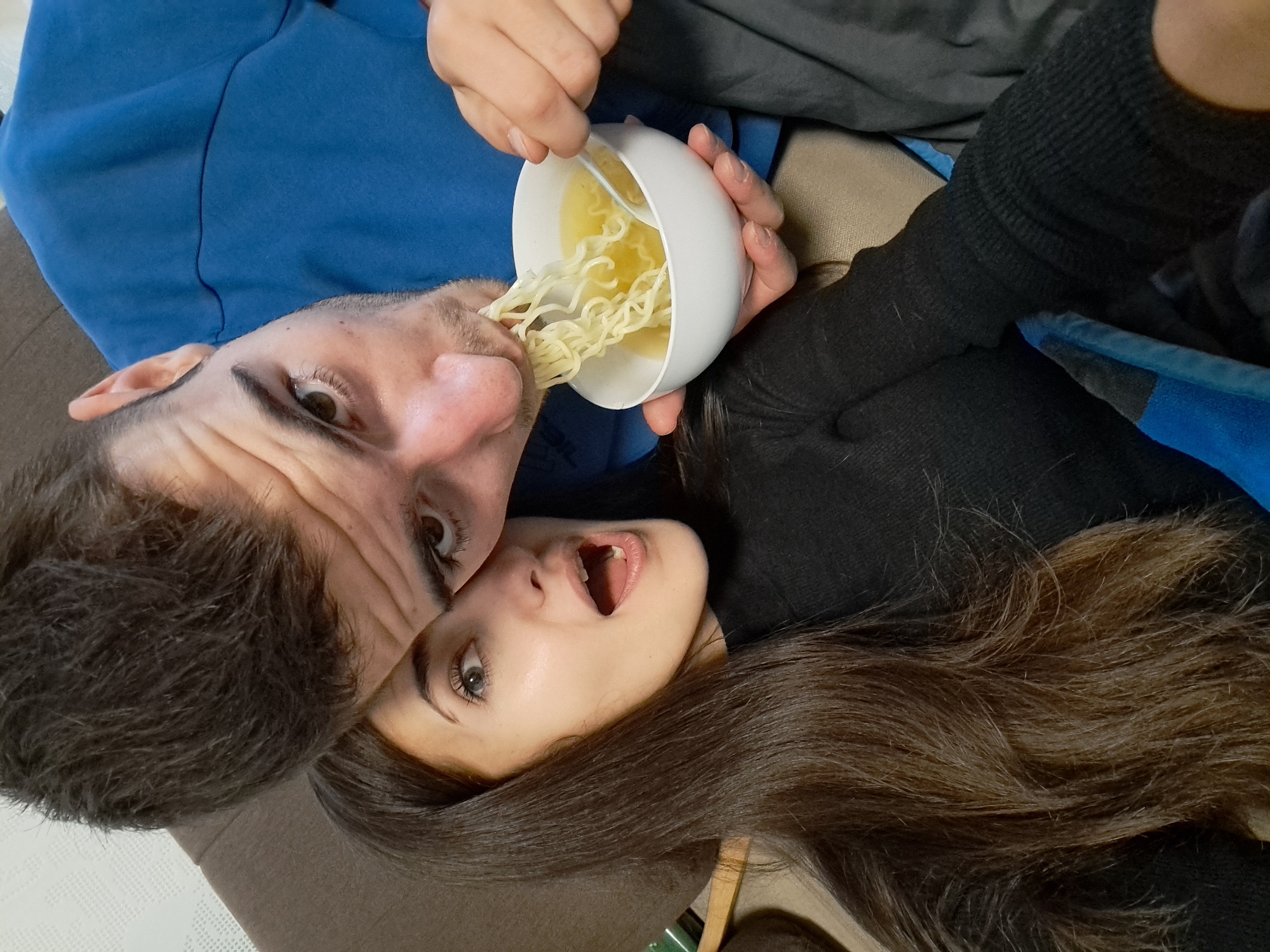 Couple shares noodle meal with decorative spoons in Bulgaria