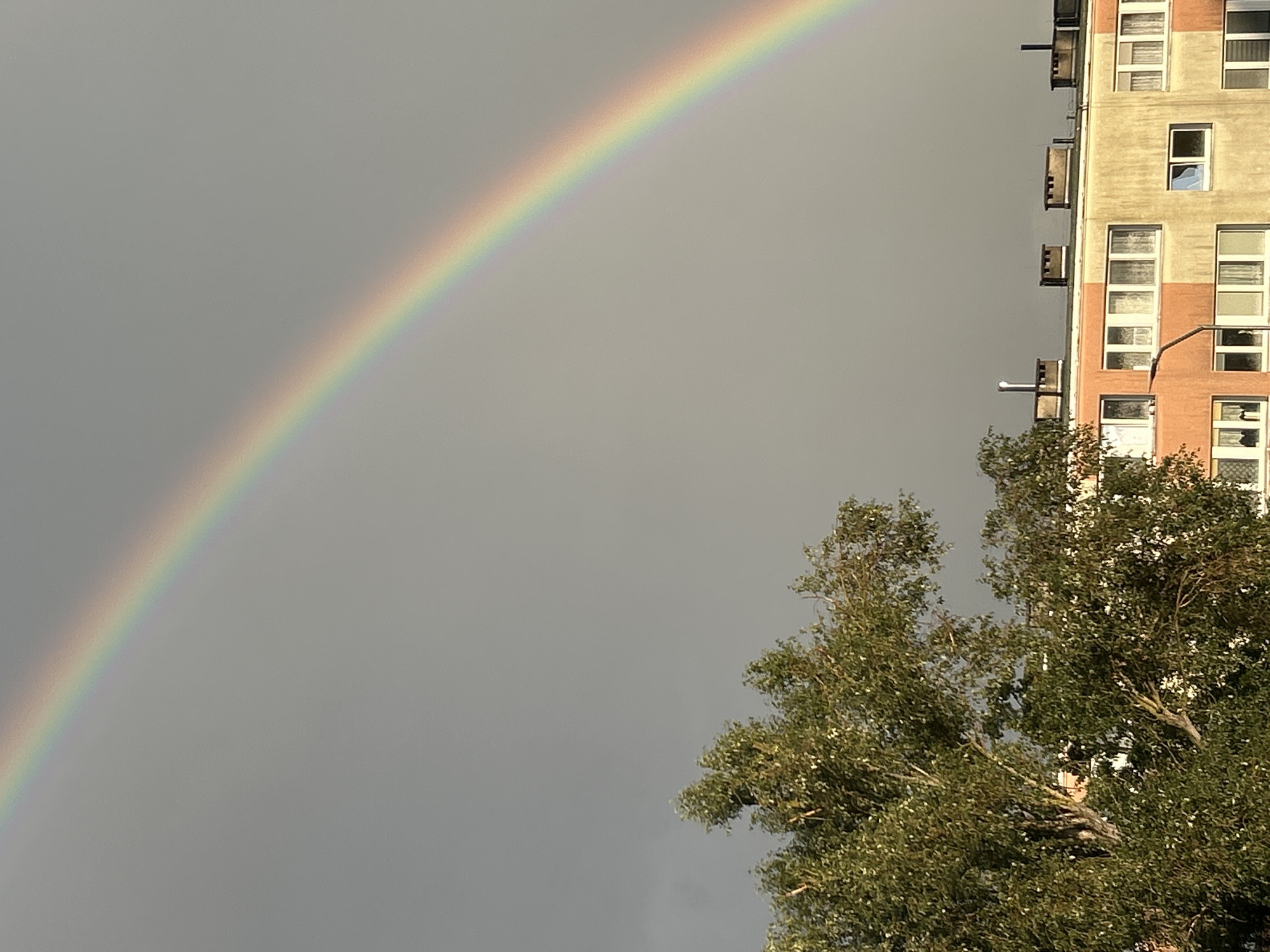 Double rainbow over Szczecin apartment block, caught from two angles