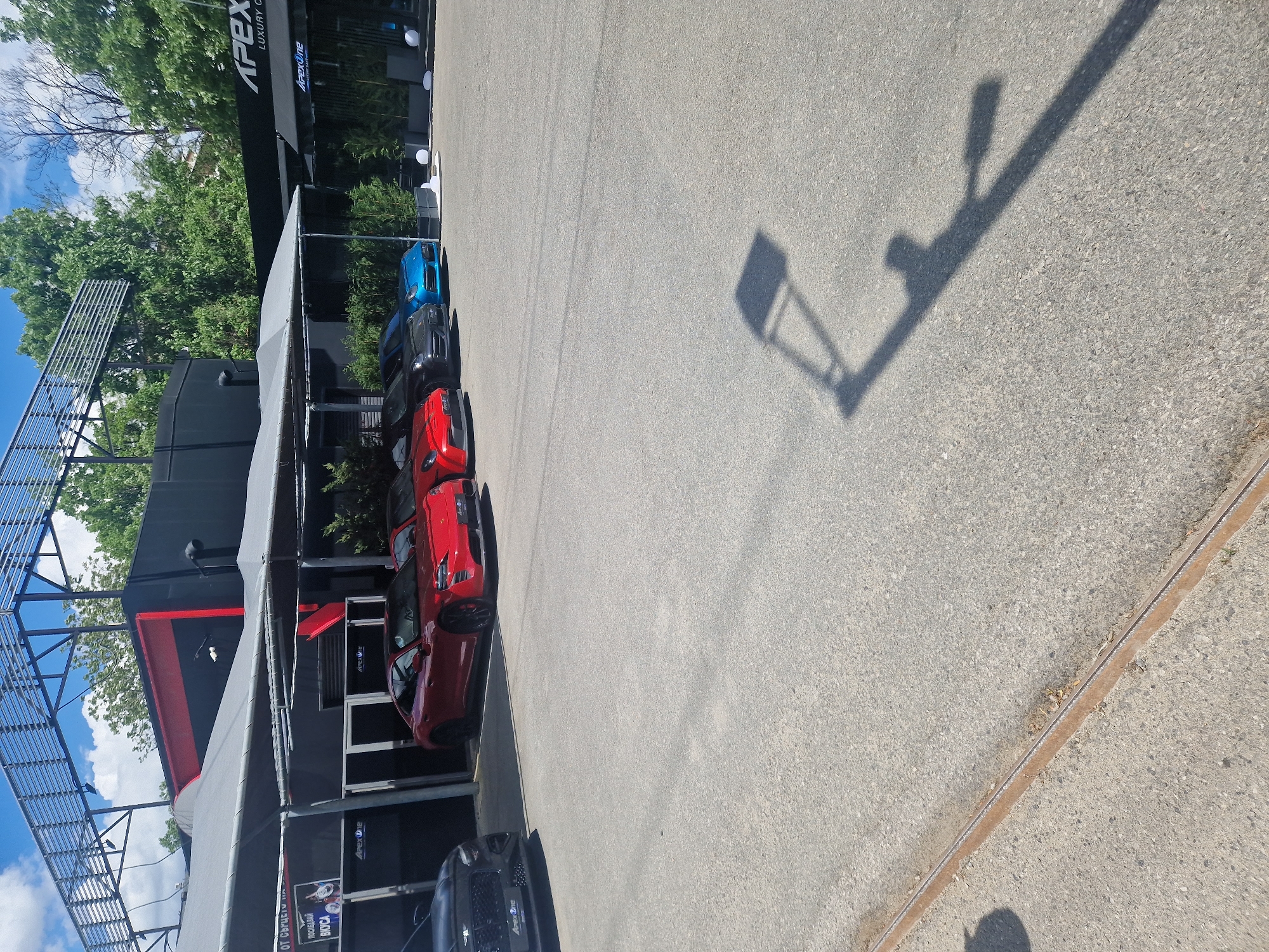 Cars parked at Apex Luxury Cars dealership lot