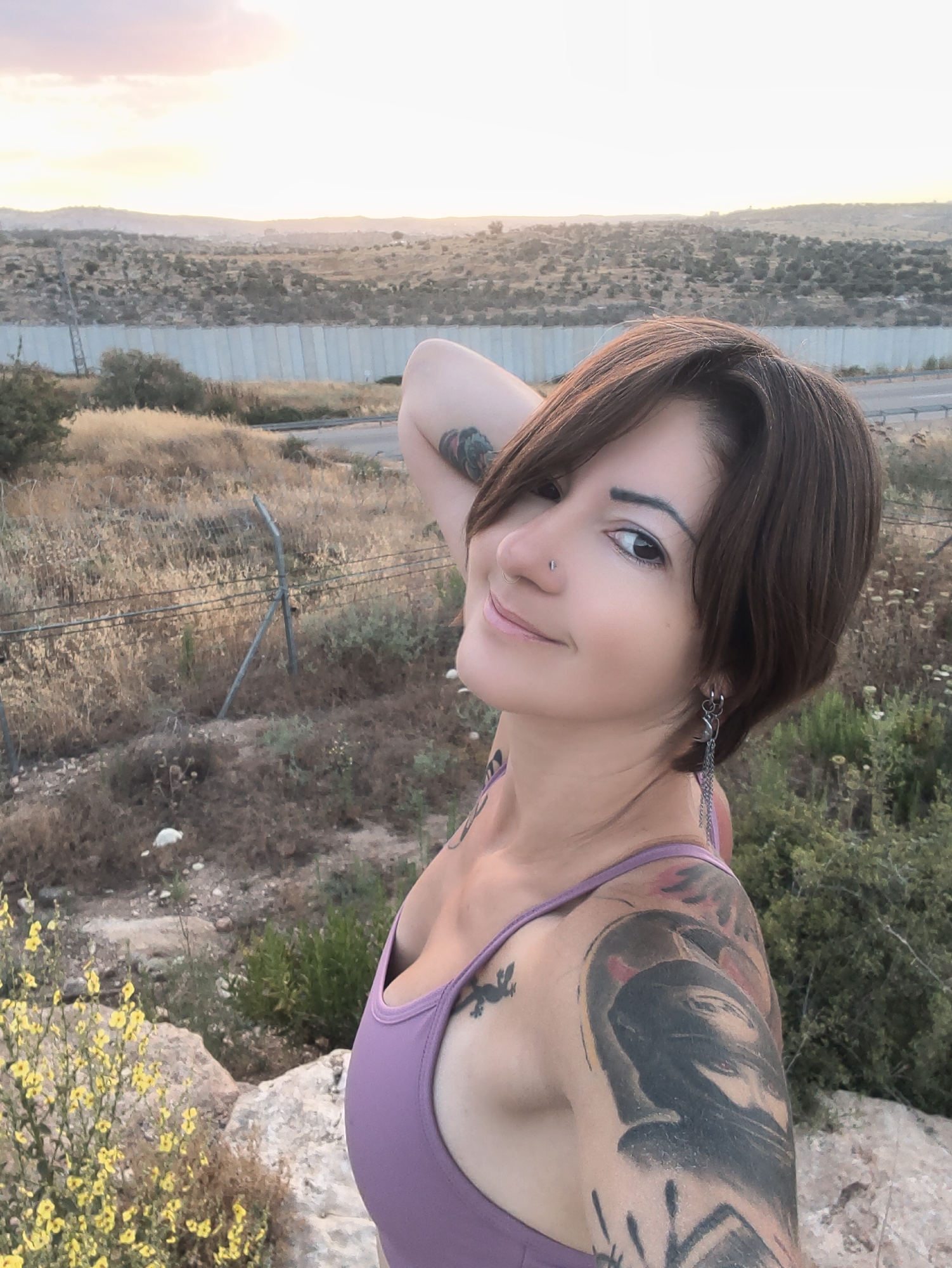 Woman photographed smiling at sunset near Beit Awwa