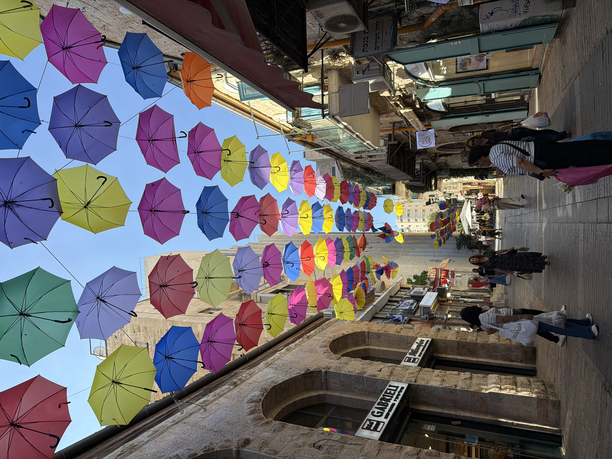Jerusalem Old City market stroll with umbrella canopies and ceramics