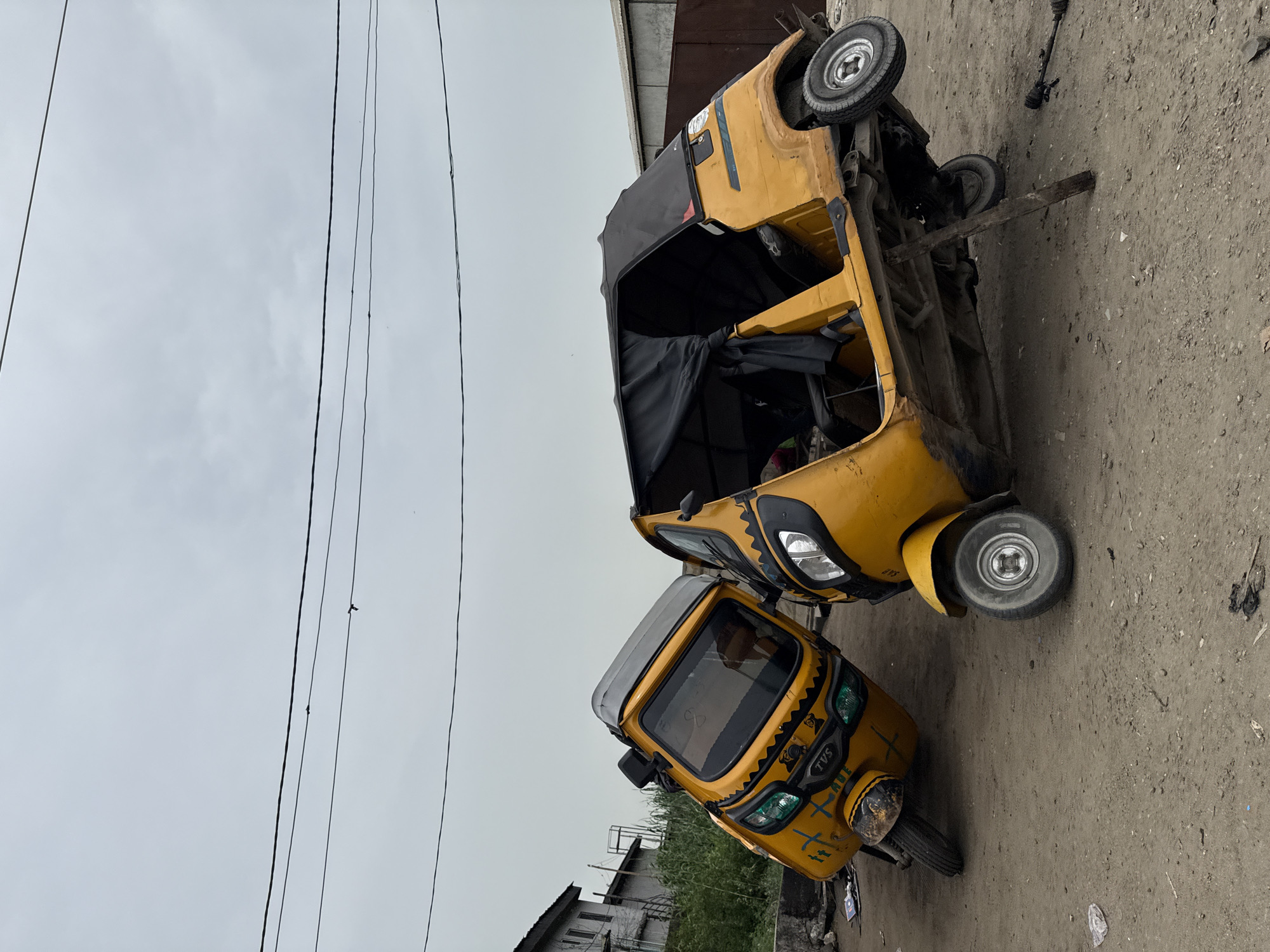 Daily life moments captured in Ado: overturned keke, sugar cane vendor