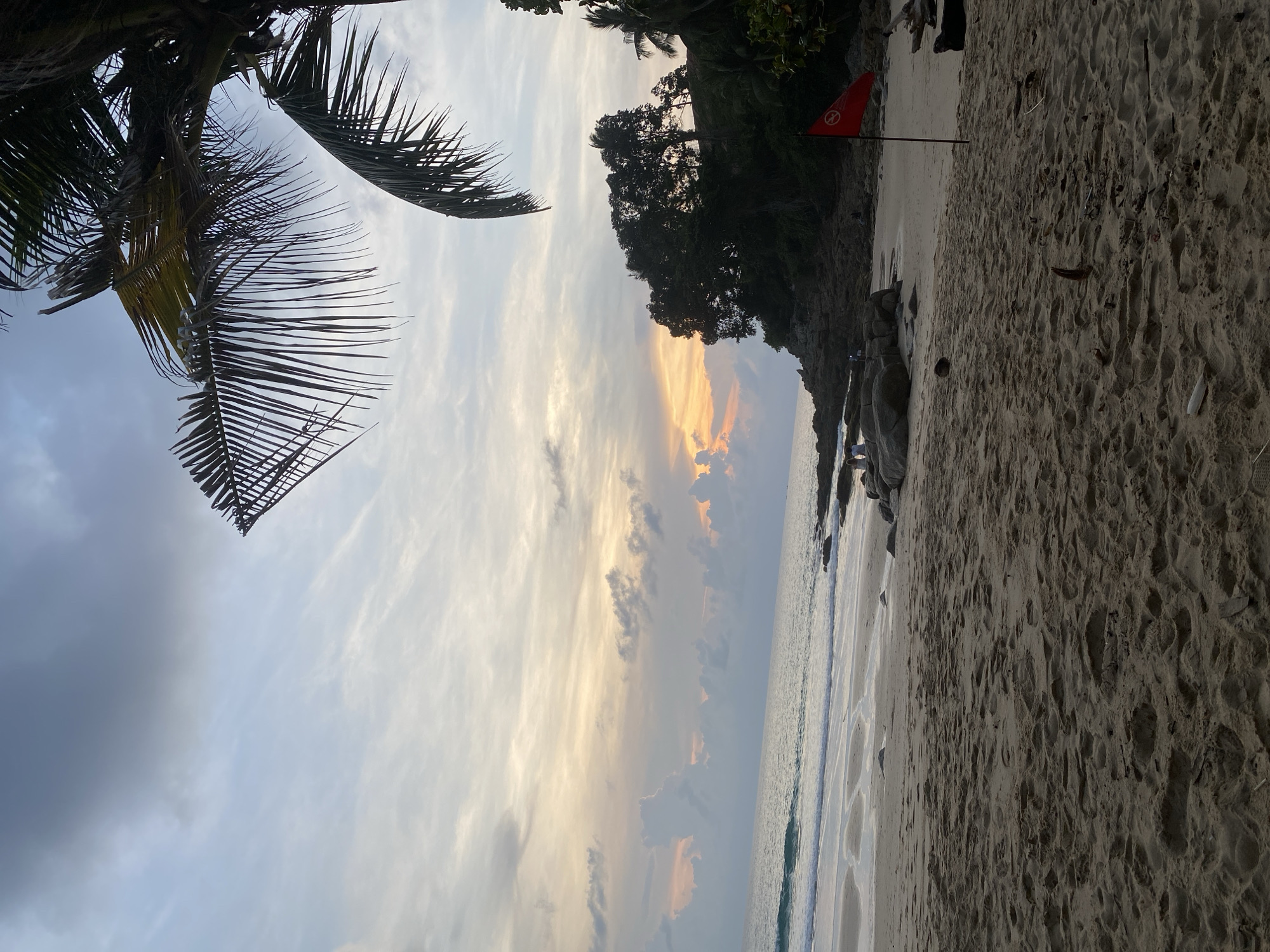 Sunset on a palm-lined beach in Choeng Thale