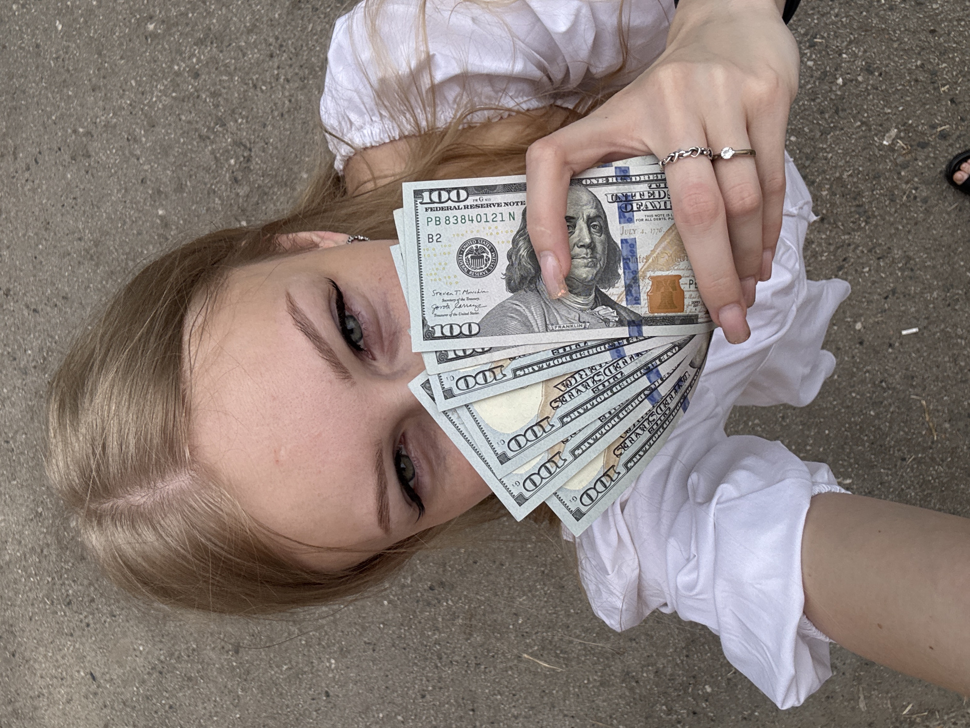 Fanning US $100 bills outdoors in Perm, Russia