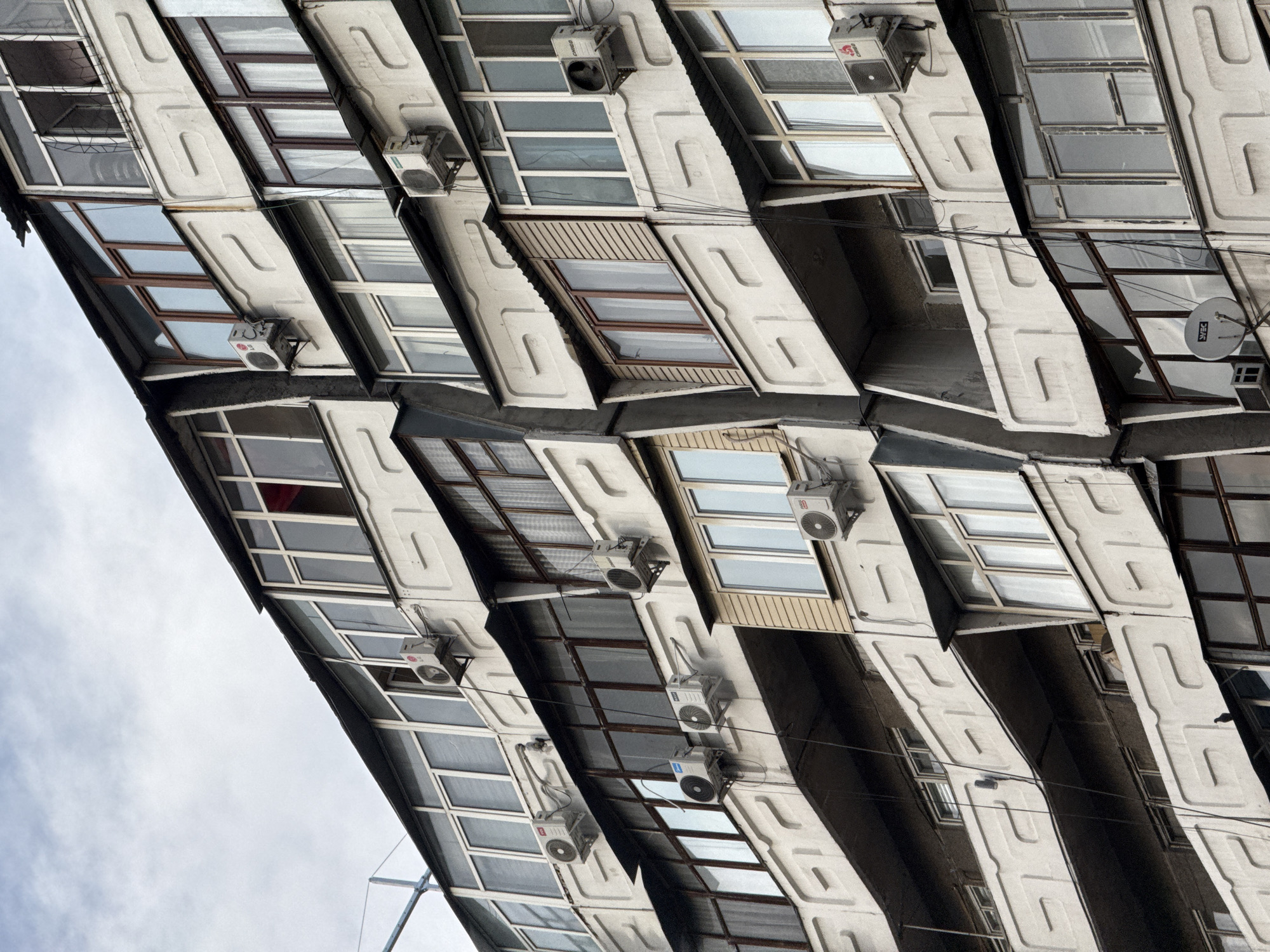 Mountain city streets, dense apartment blocks, and a cannabis plant
