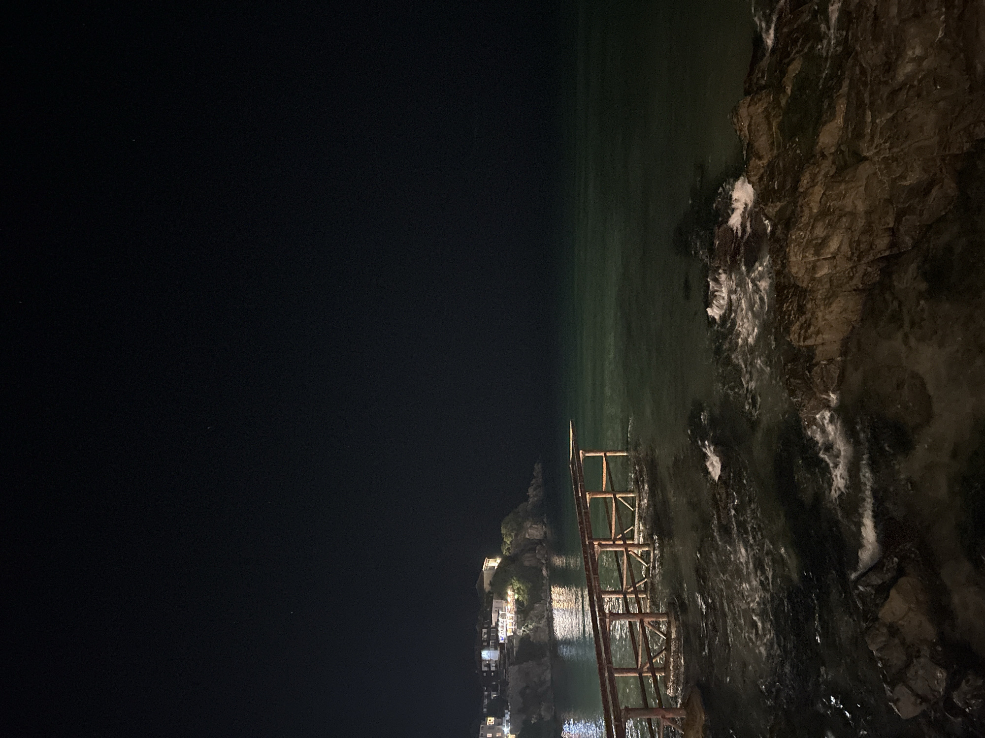 Sozopol's lit coastline meets the Black Sea at night