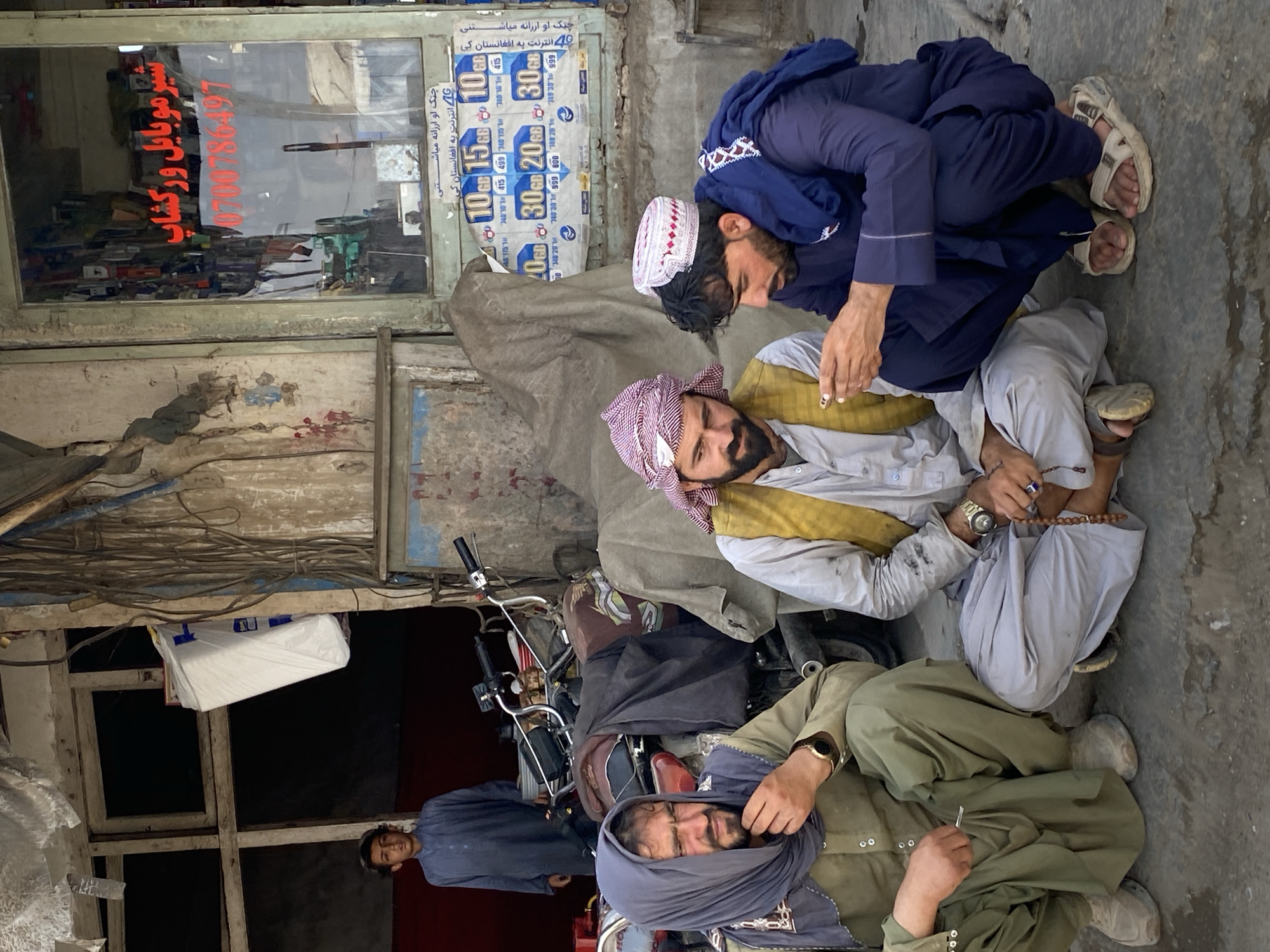 Everyday street life across a busy Kandahar block