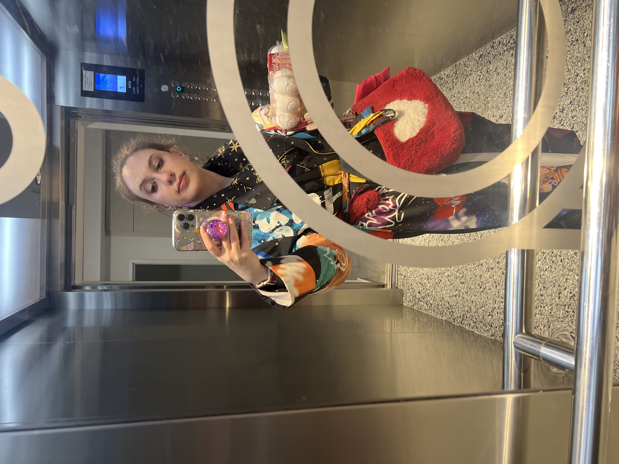 Woman takes elevator mirror selfie in Tbilisi
