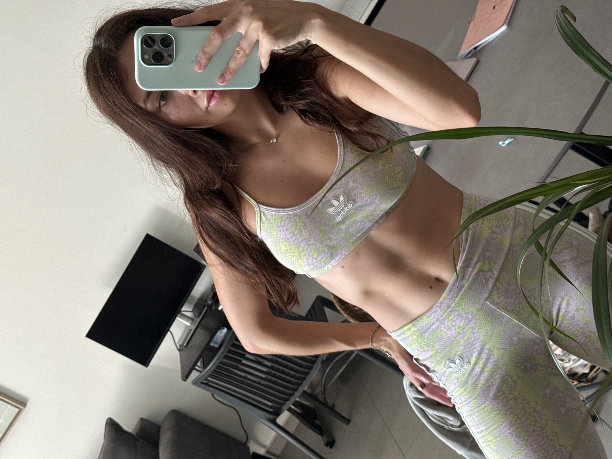 Woman takes mirror selfie in athletic wear in Tel Aviv