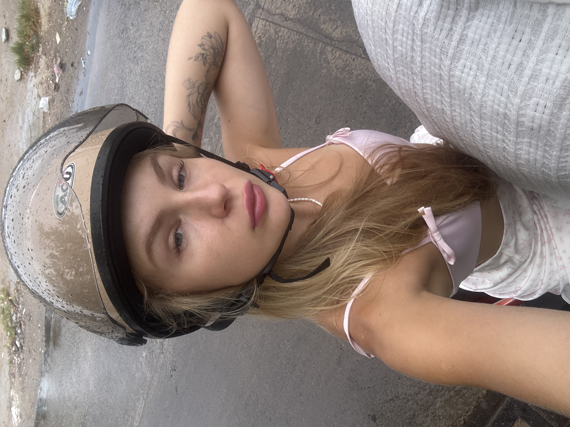 Helmeted person lying down on a street in Nha Trang