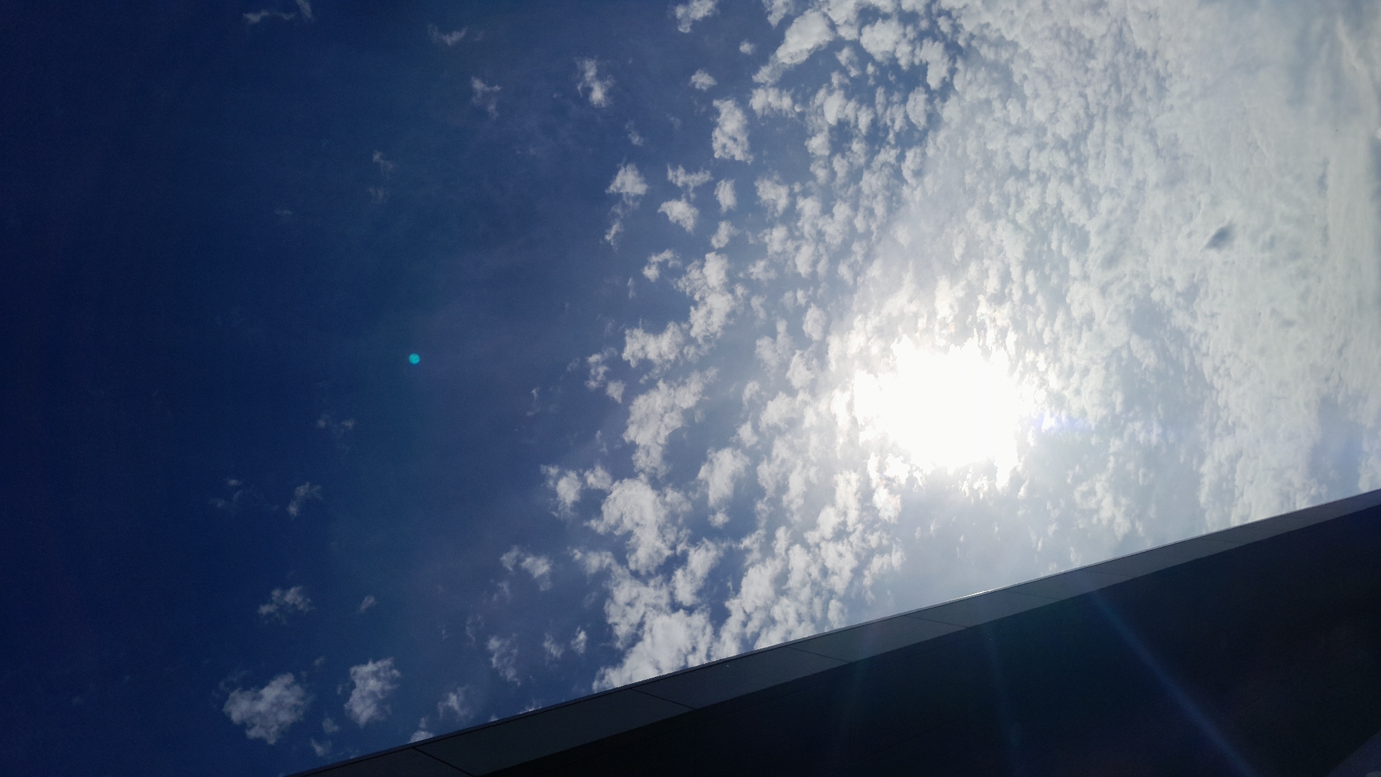 Midday sun and clouds over Kraków, shot from street level