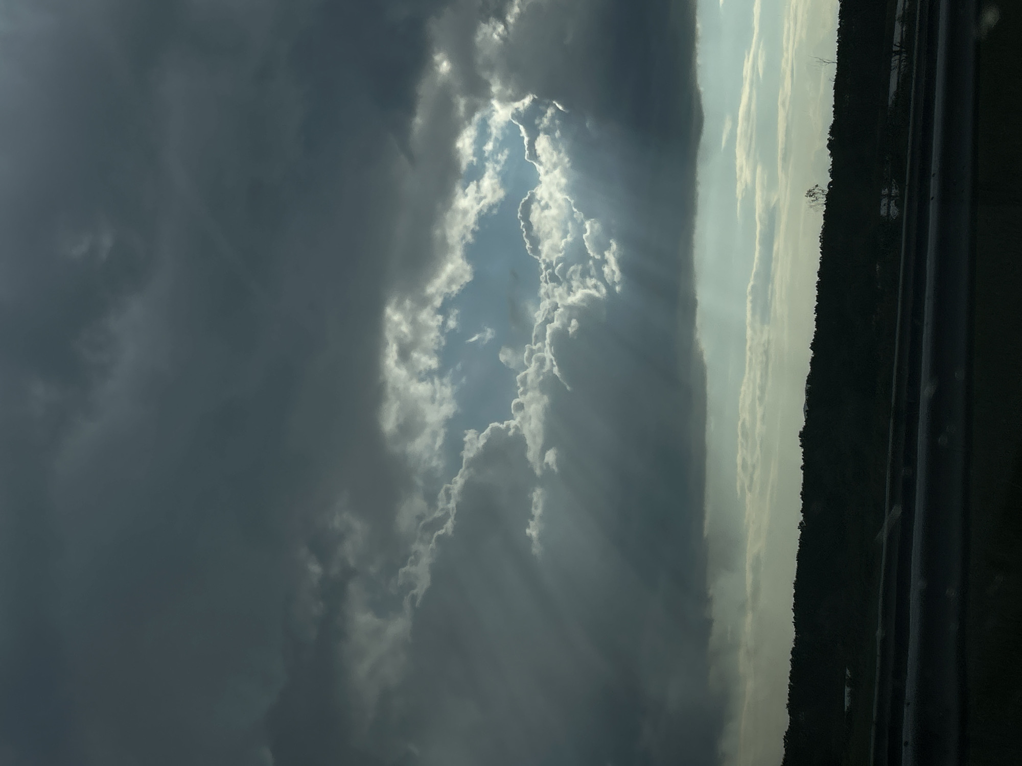 Sunbeams pierce dark clouds over Bulgarian village