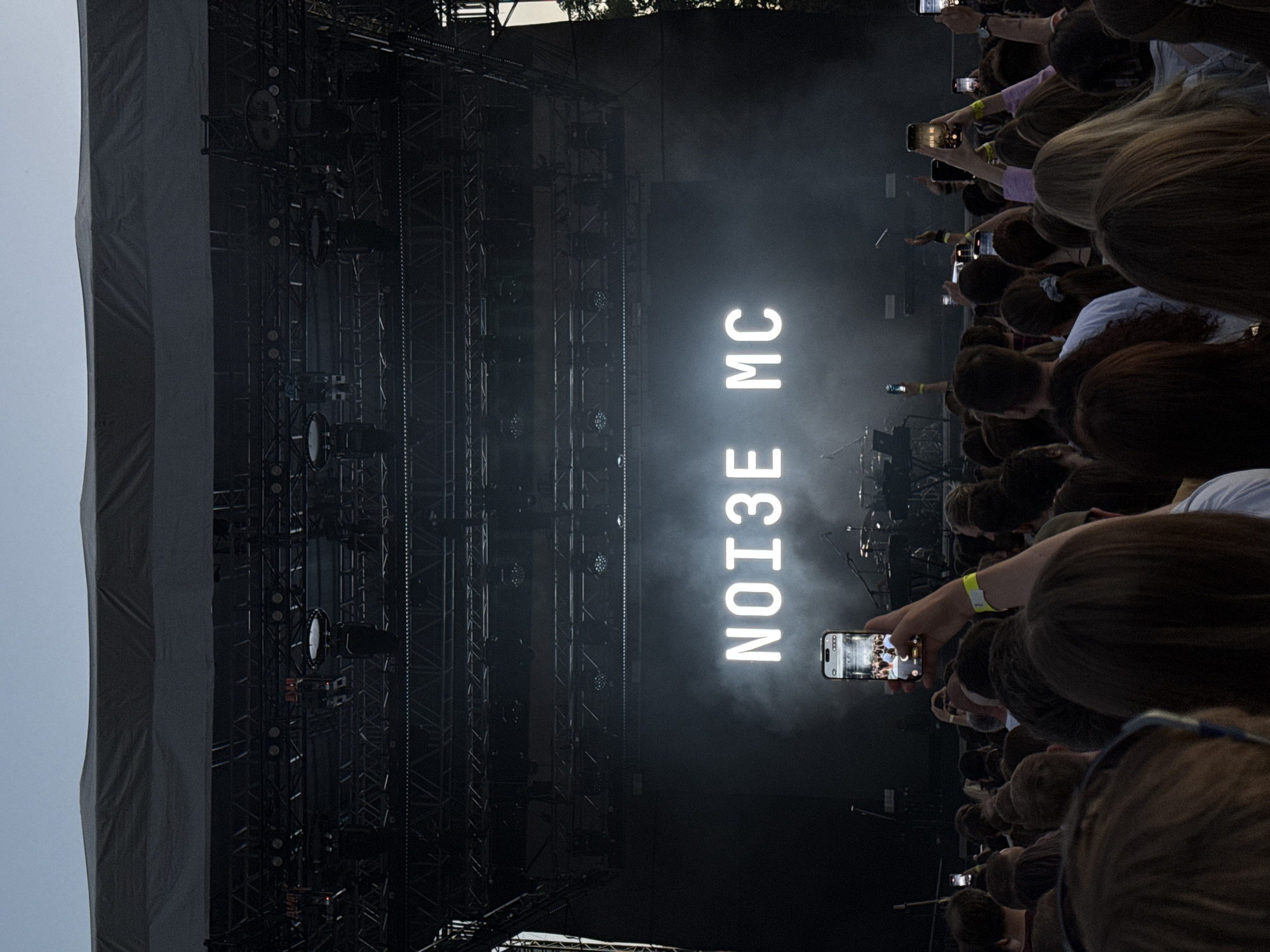 NOISE MC concert at outdoor venue with illuminated stage