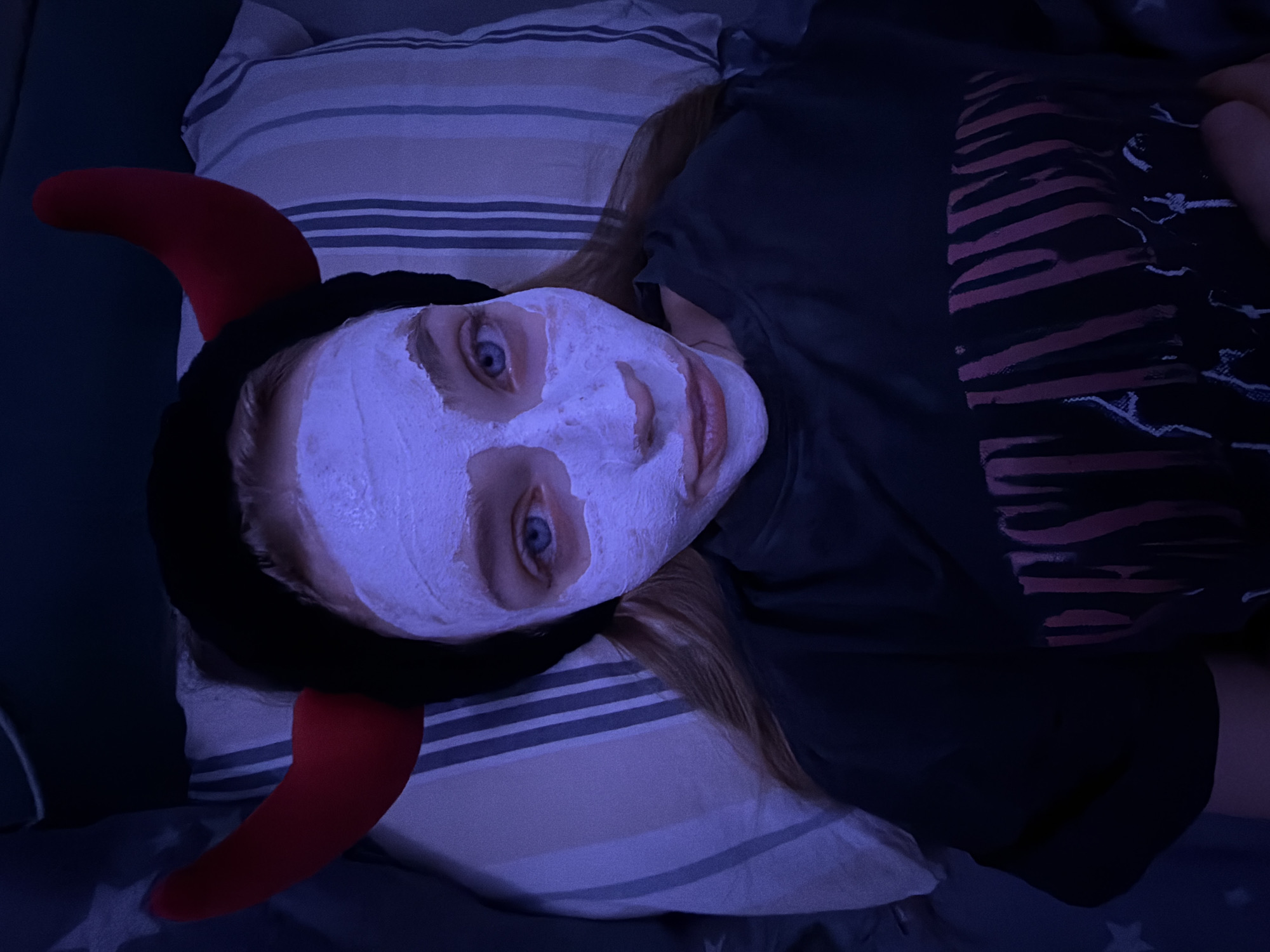 Face mask and devil horns: a casual self-care moment at home