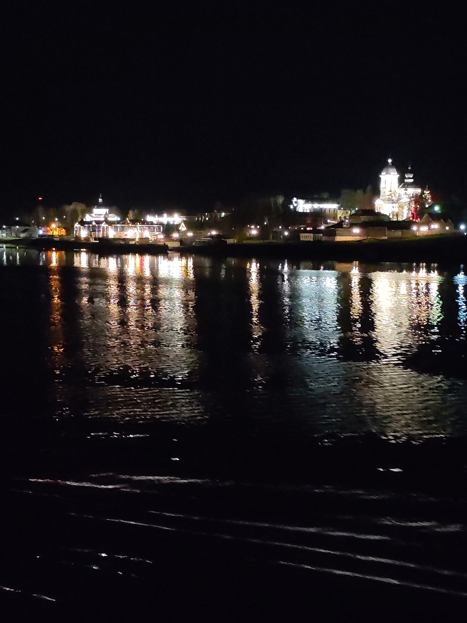 Nighttime waterfront reflections documented in Nesterovo, Russia