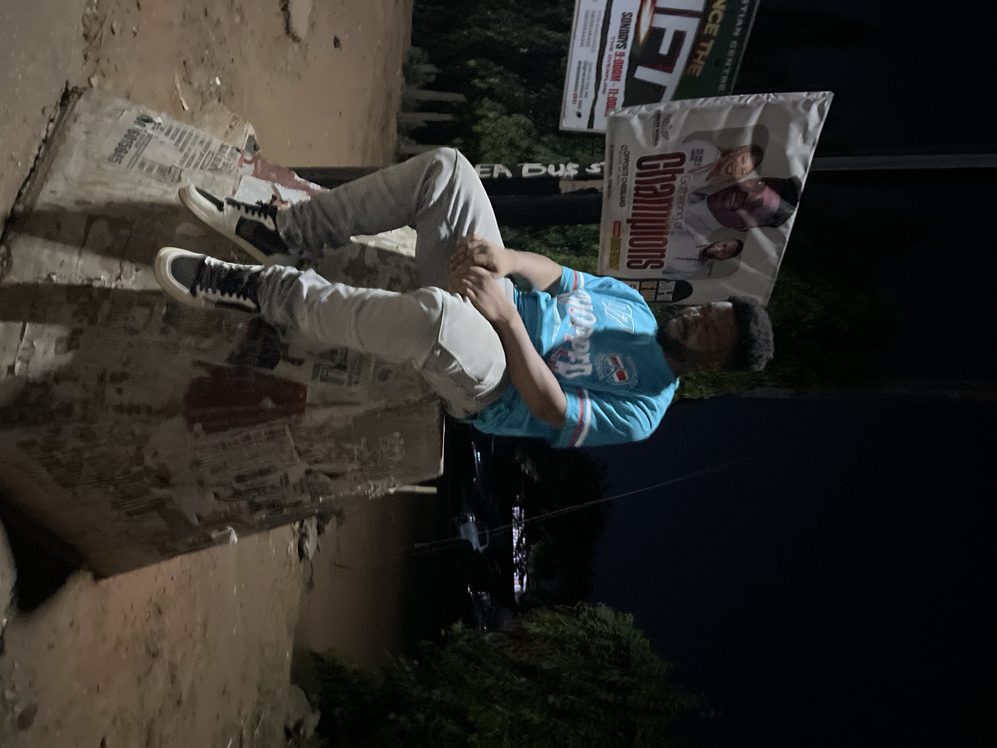 Man rests on concrete with papers in Abuja
