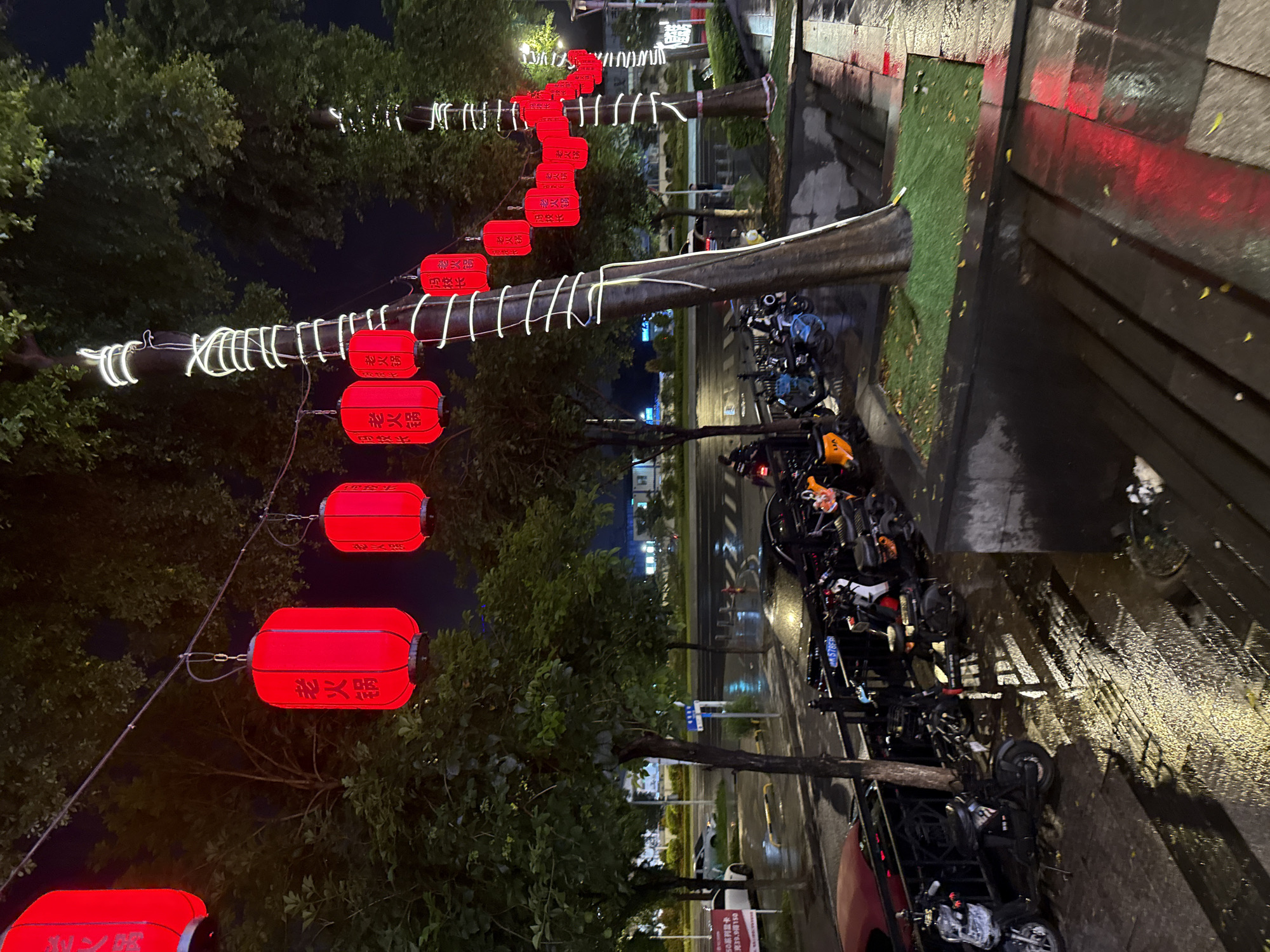 Rainy night on a Haizhu District street, barbecue stalls and neon signs