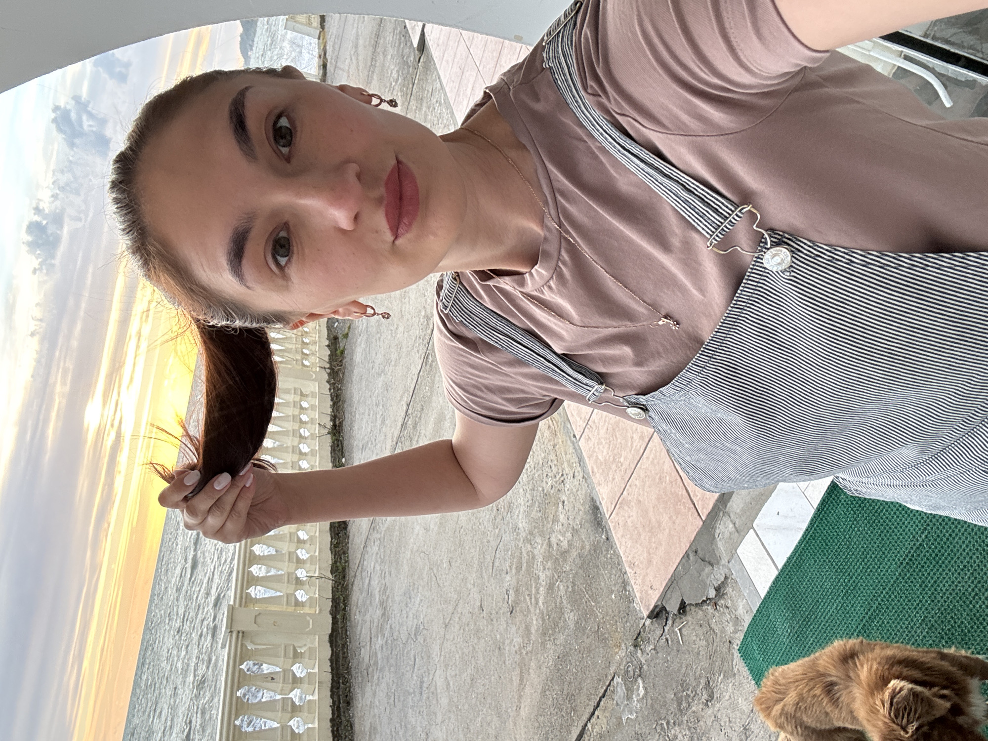 Woman enjoys sunset moments with dog at Sochi waterfront