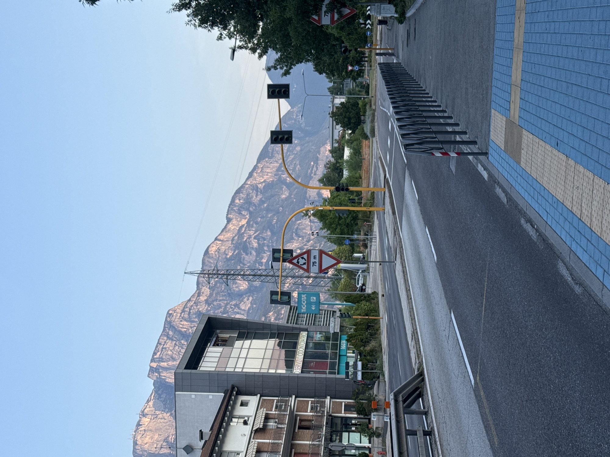 Street scenes in Trento with mountain backdrop and opera festival poster
