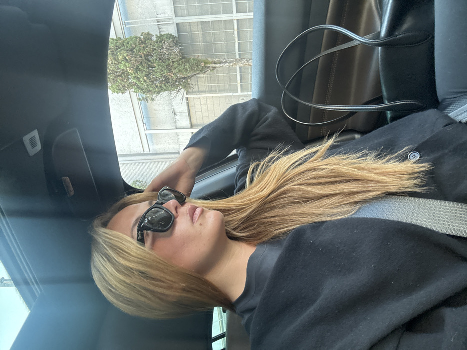 Woman rests in passenger seat during evening in Mexico City
