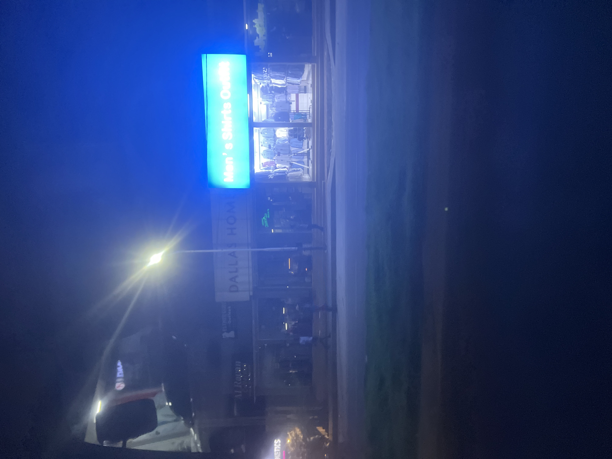Illuminated storefronts observed at night in Dar es Salaam