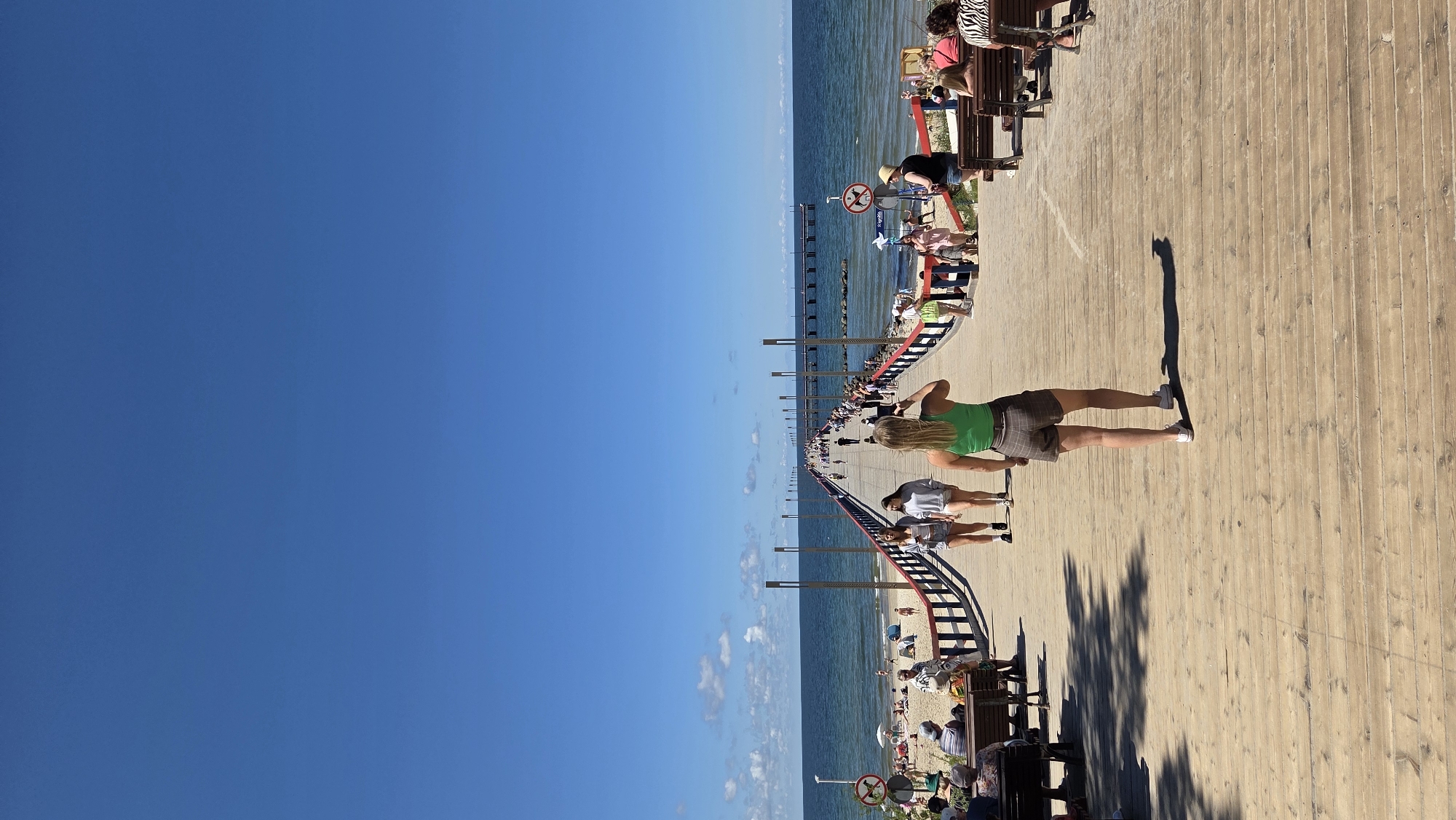 Palanga pier, beach, and amusement area on a sunny summer morning