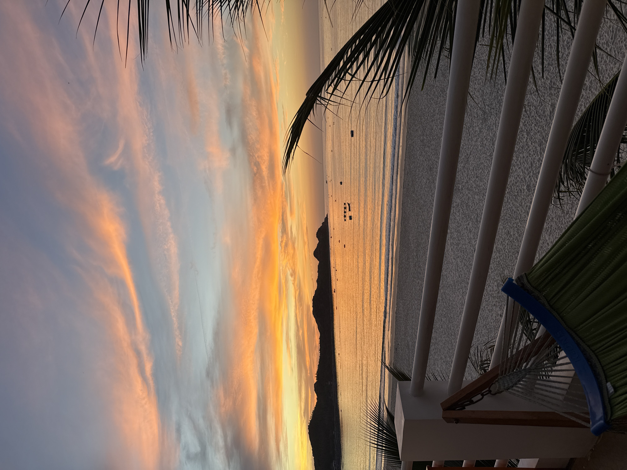 Beach sunset with mountain silhouette, balcony views included