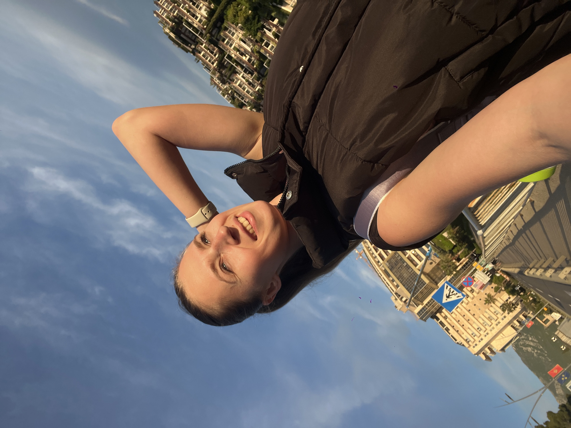 Couple photographed on bridge overlooking Budva coastline during golden hour