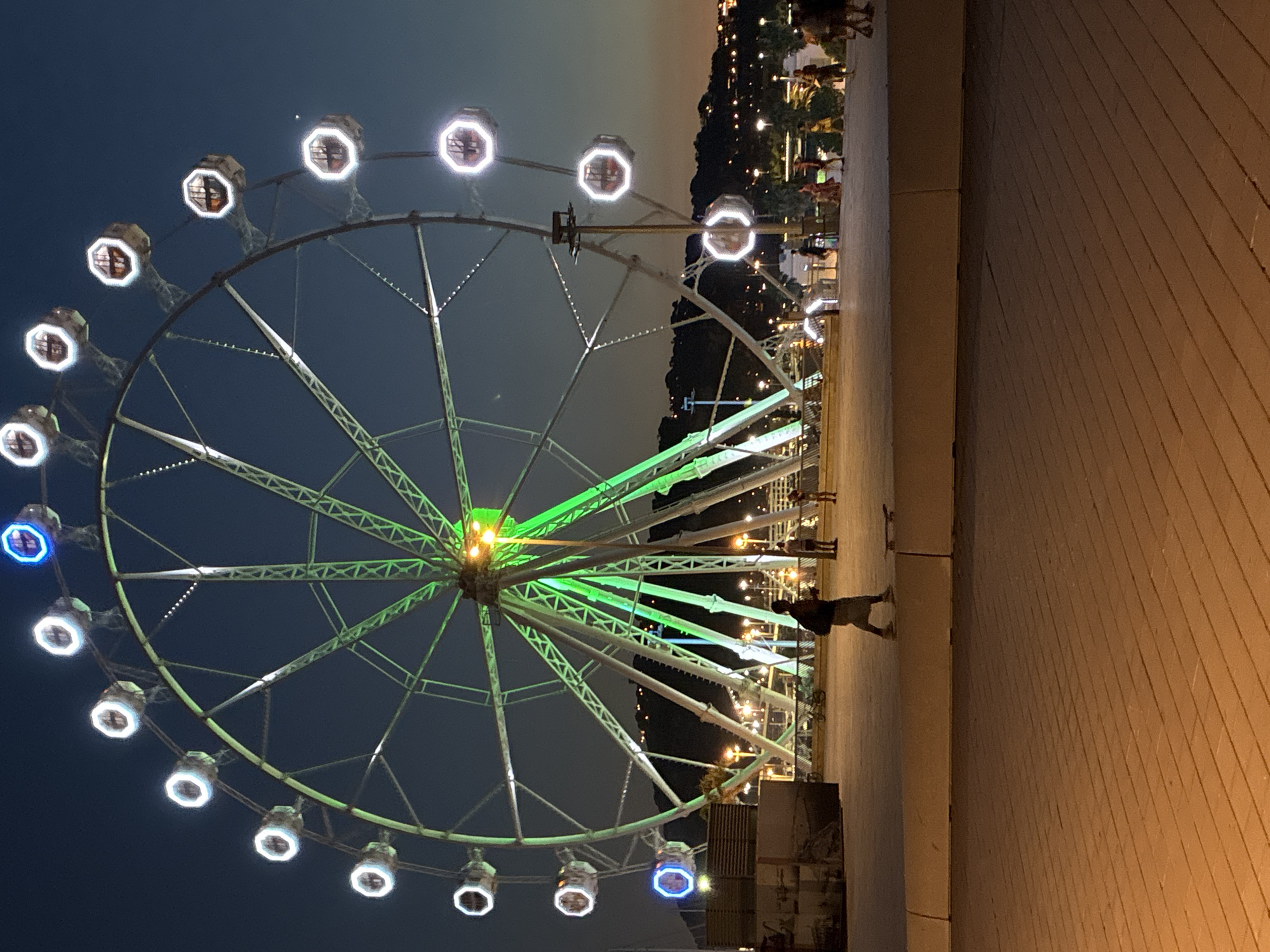 Ferris wheel glowing over Barcelona's waterfront at dusk